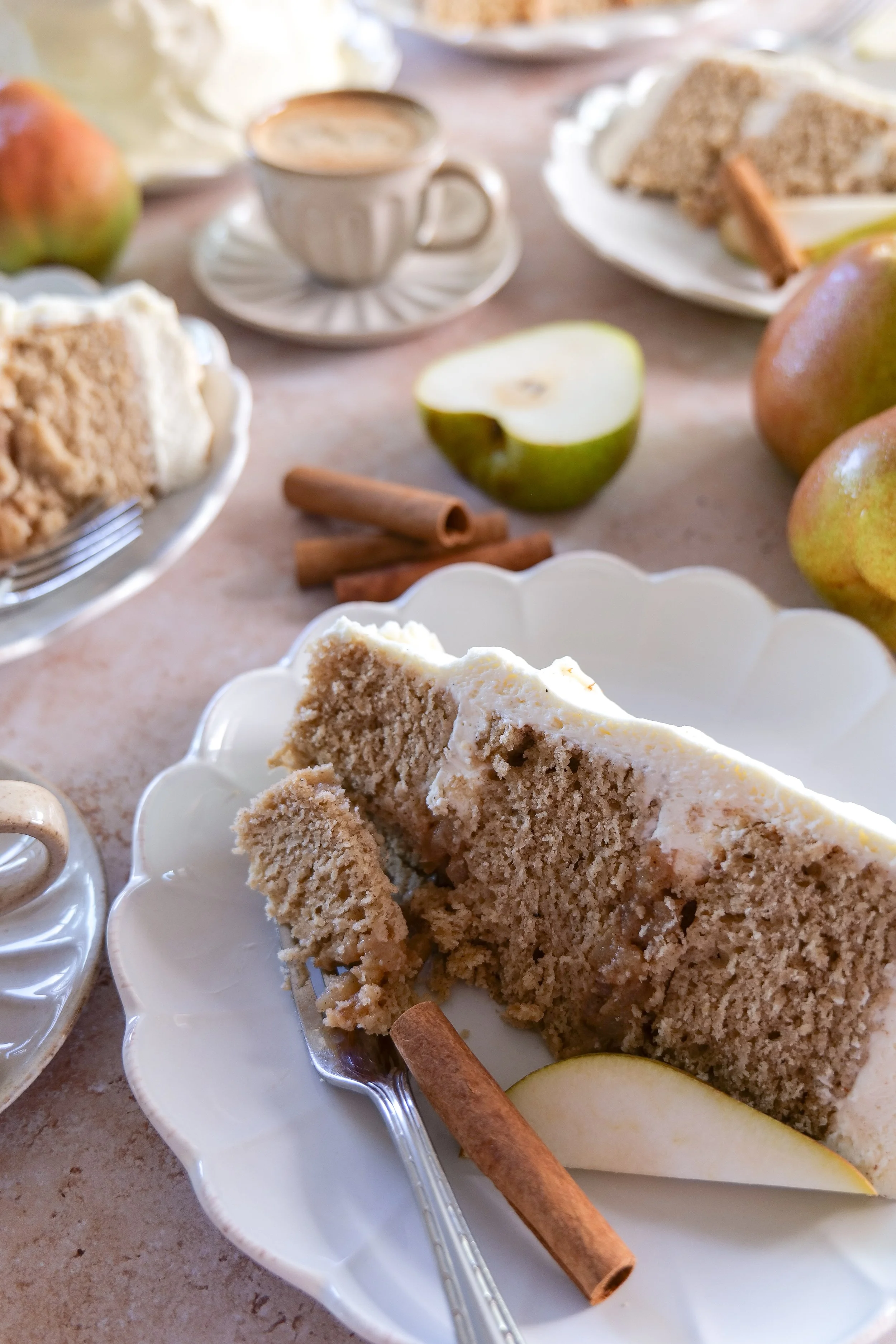 Slice of brown butter pear cake showing pear filling and mascarpone cream between the layers.