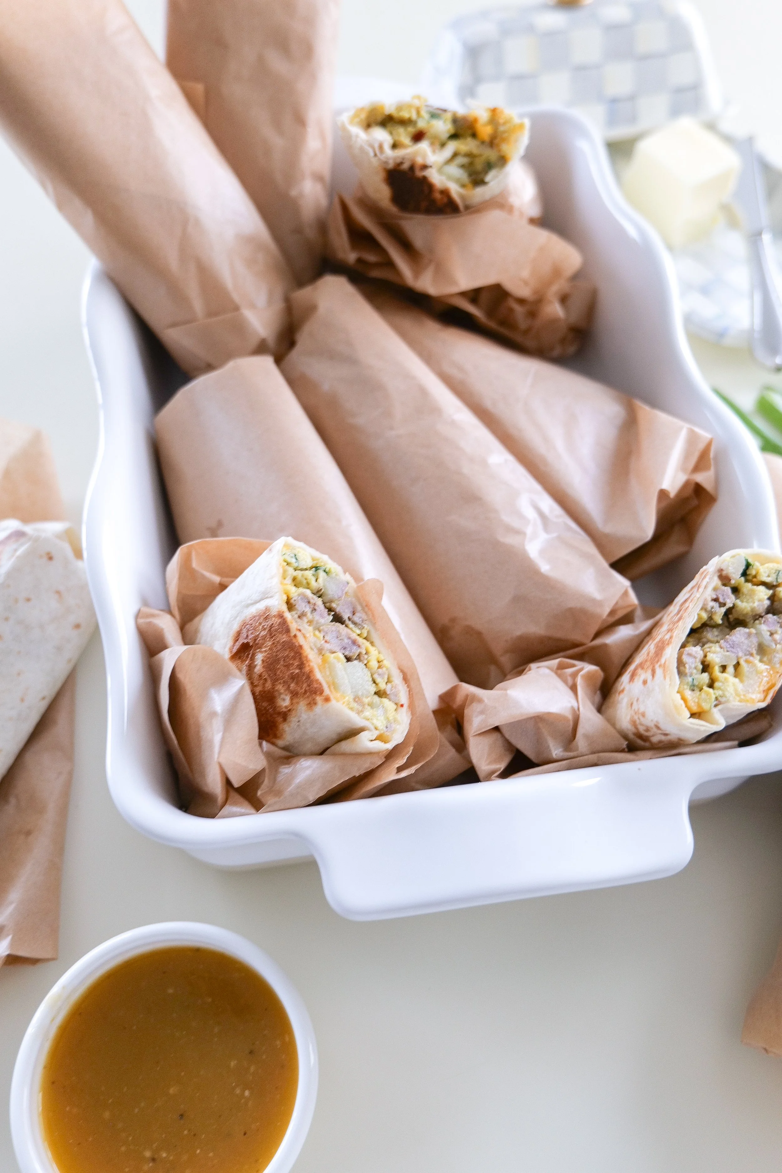 Freezer-friendly homemade breakfast burritos with toasted tortillas and a hearty sausage, egg and potato filling.