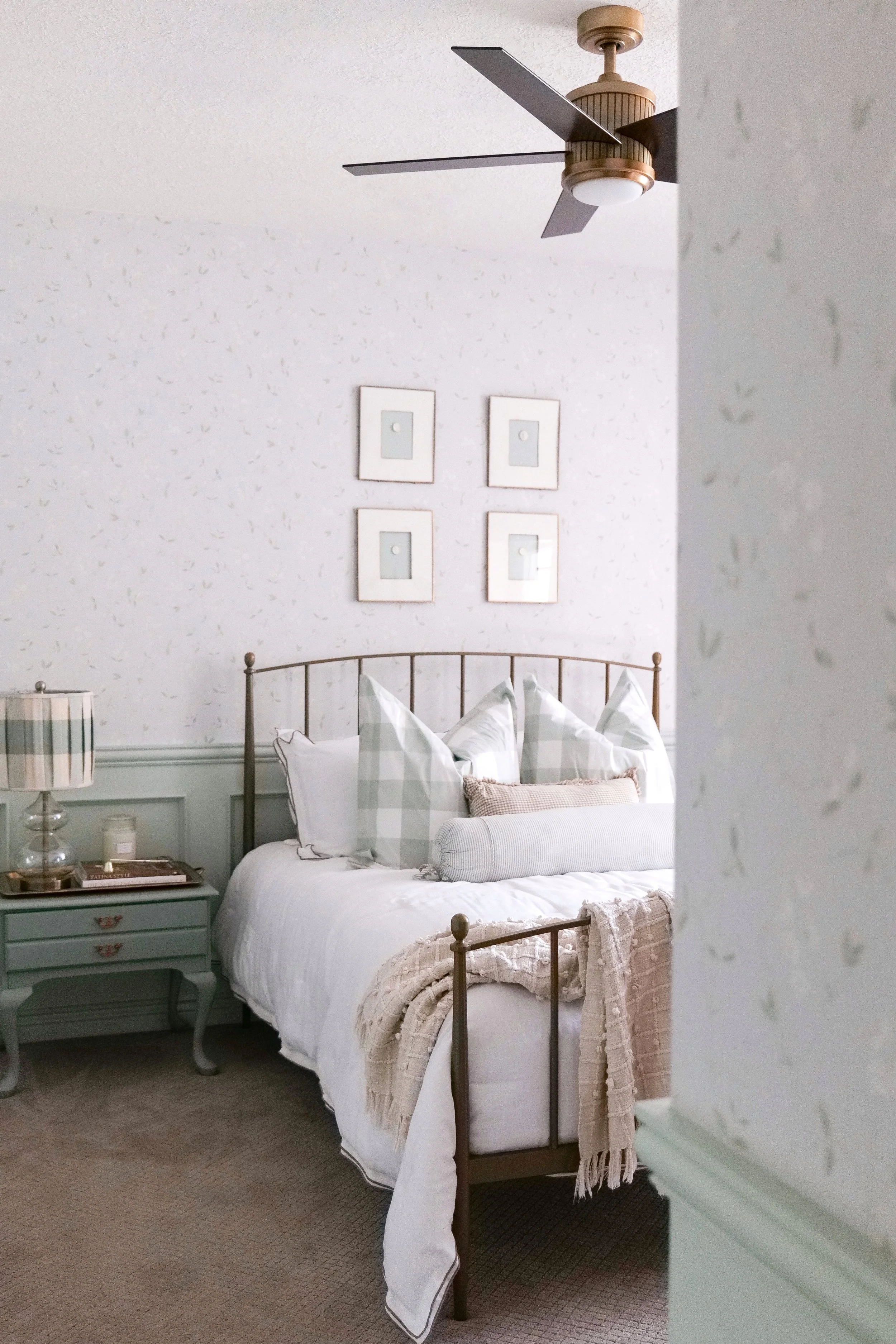 Bright traditional guest bedroom filled with natural light and soft blue accents.