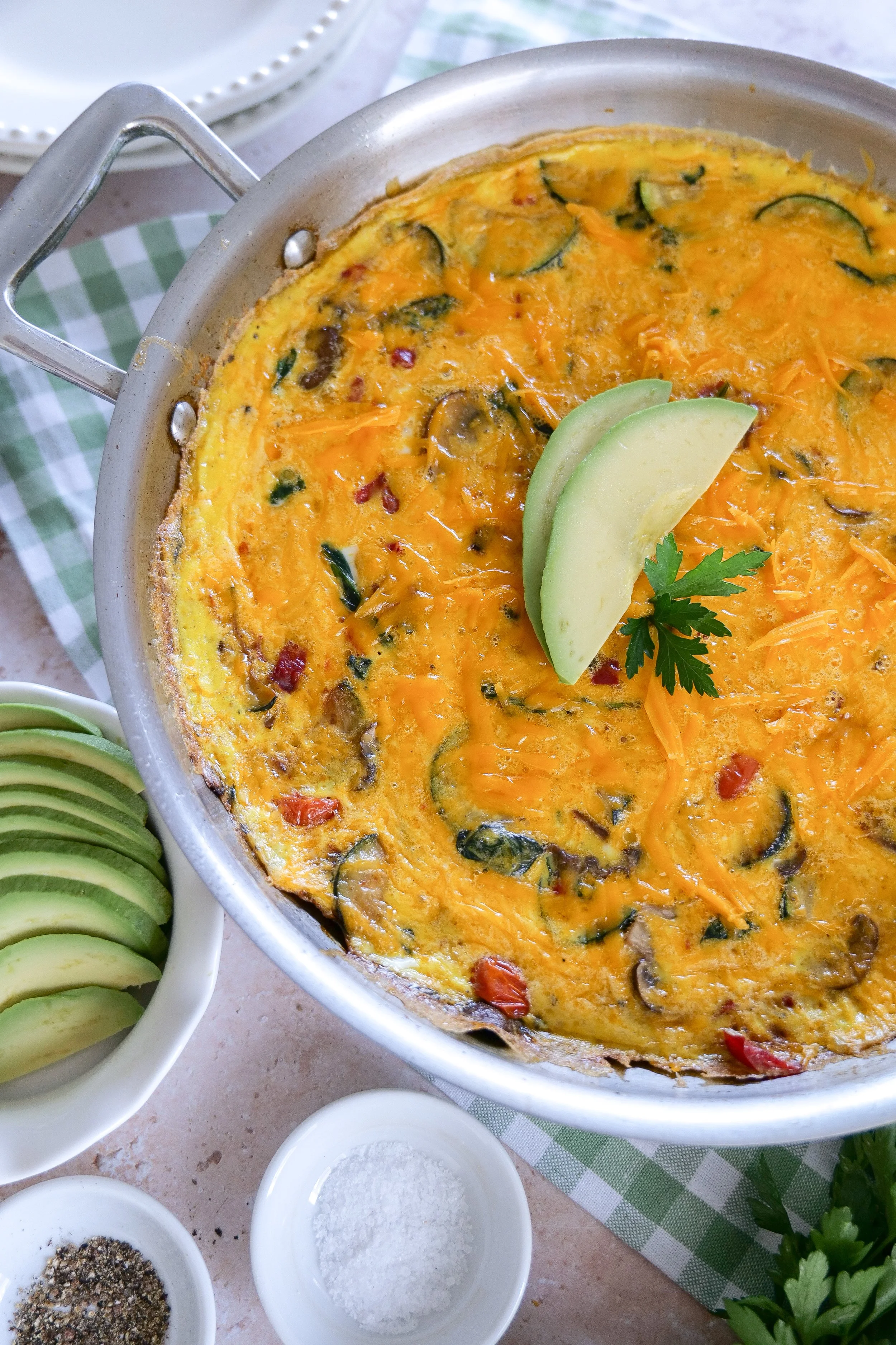Zucchini veggie frittata with eggs tomatoes and melted cheese