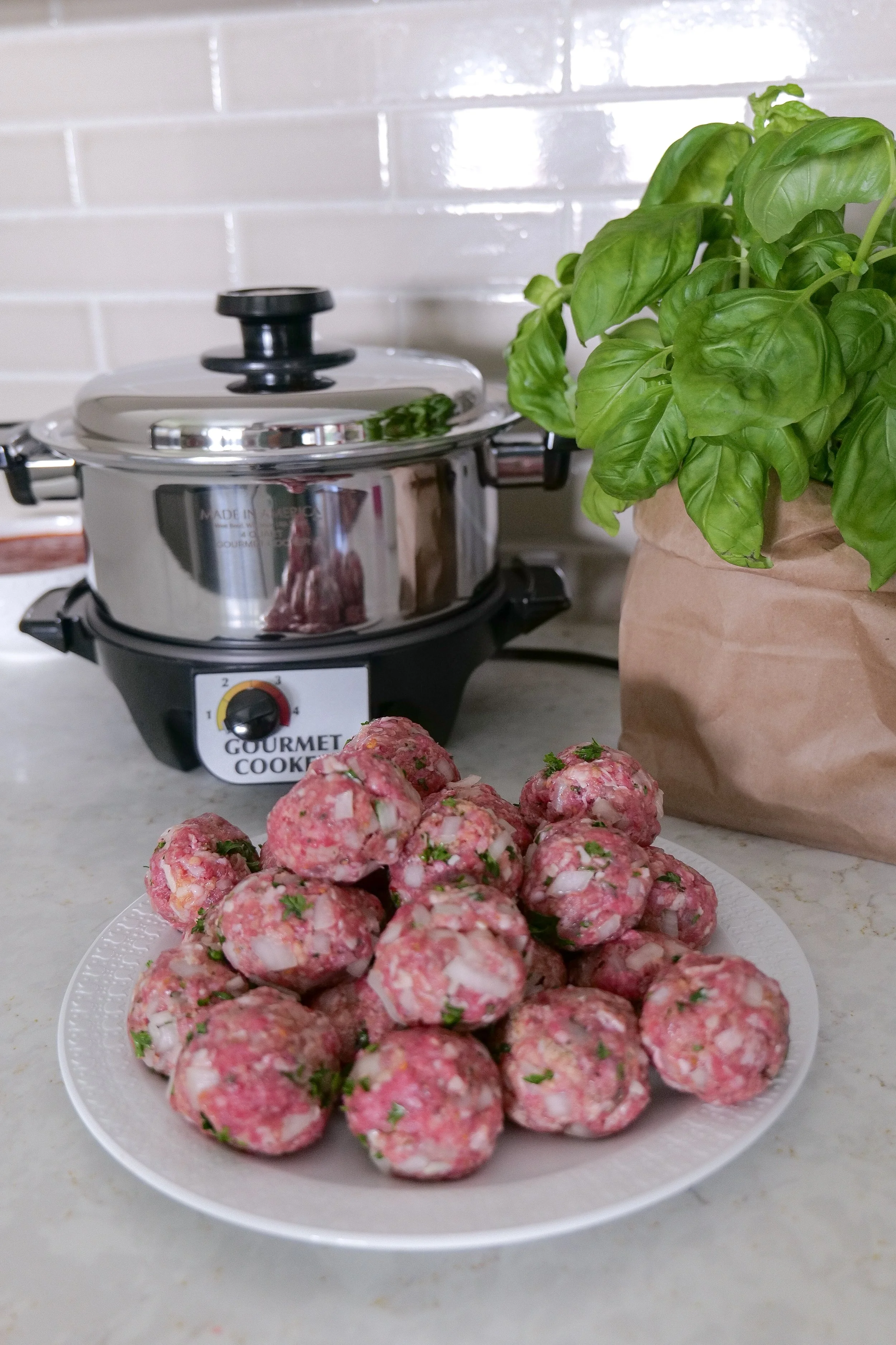 Slow cooker meatballs served over spaghetti with fresh Parmesan cheese