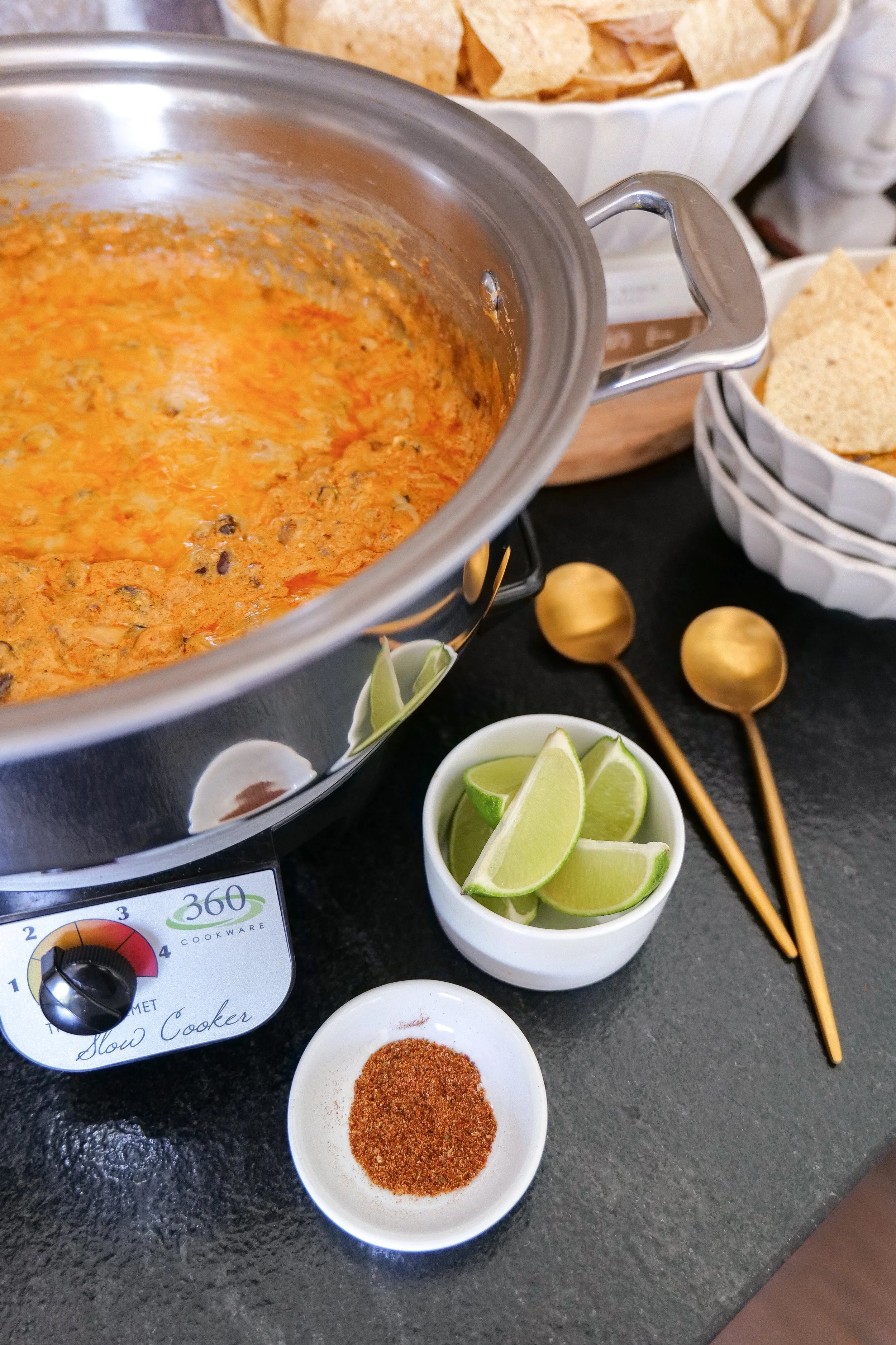 Easy slow cooker chicken dip made with enchilada sauce, cream cheese, black beans and shredded cheese.