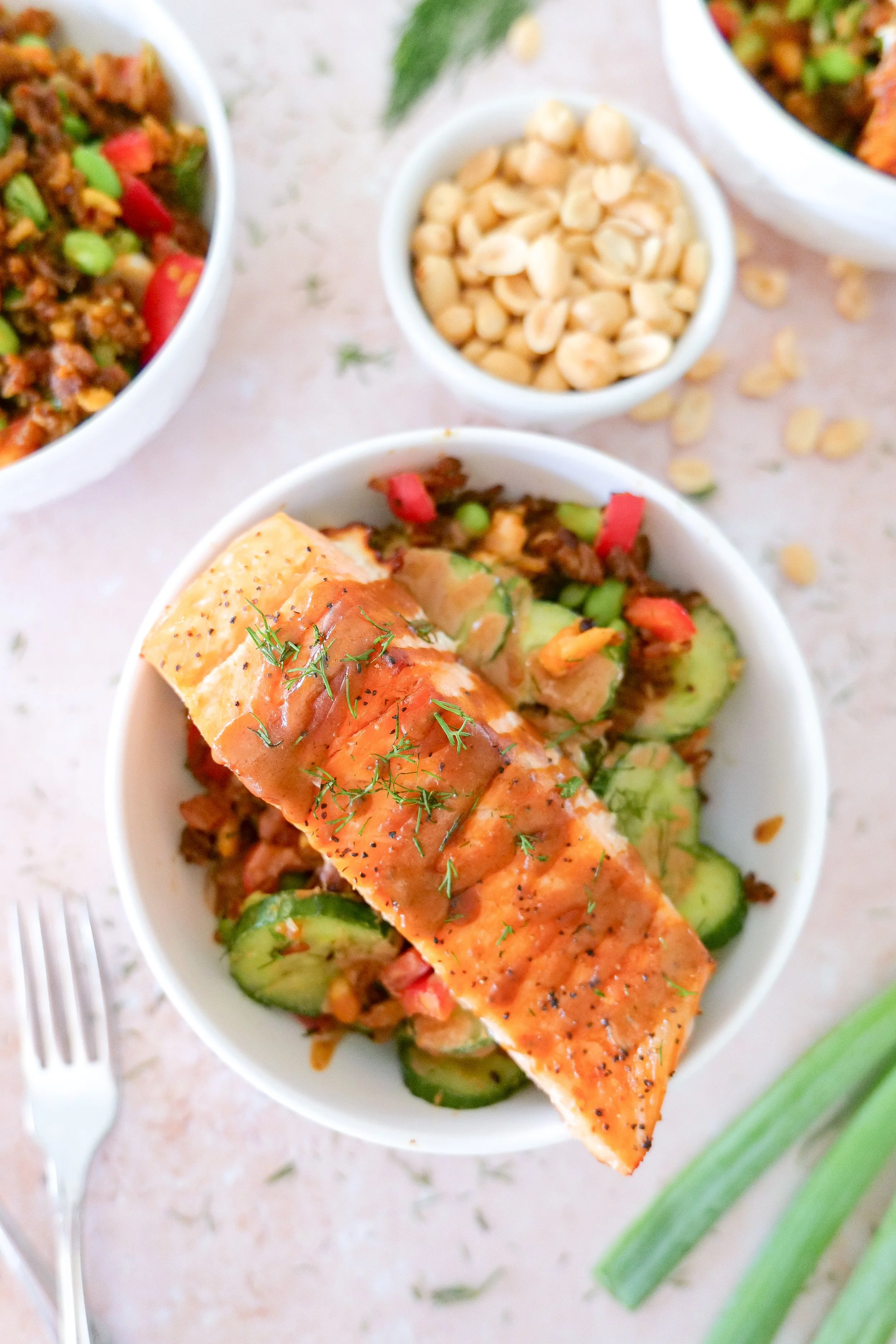 Pan-seared salmon with creamy peanut-chili sauce served over crispy rice salad.