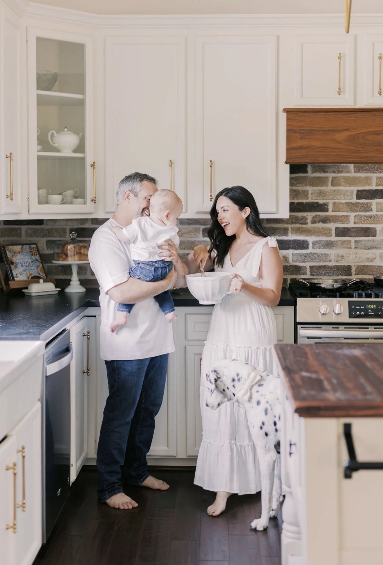Family making pancakes together with their Dalmatian in the kitchen of their Texas home