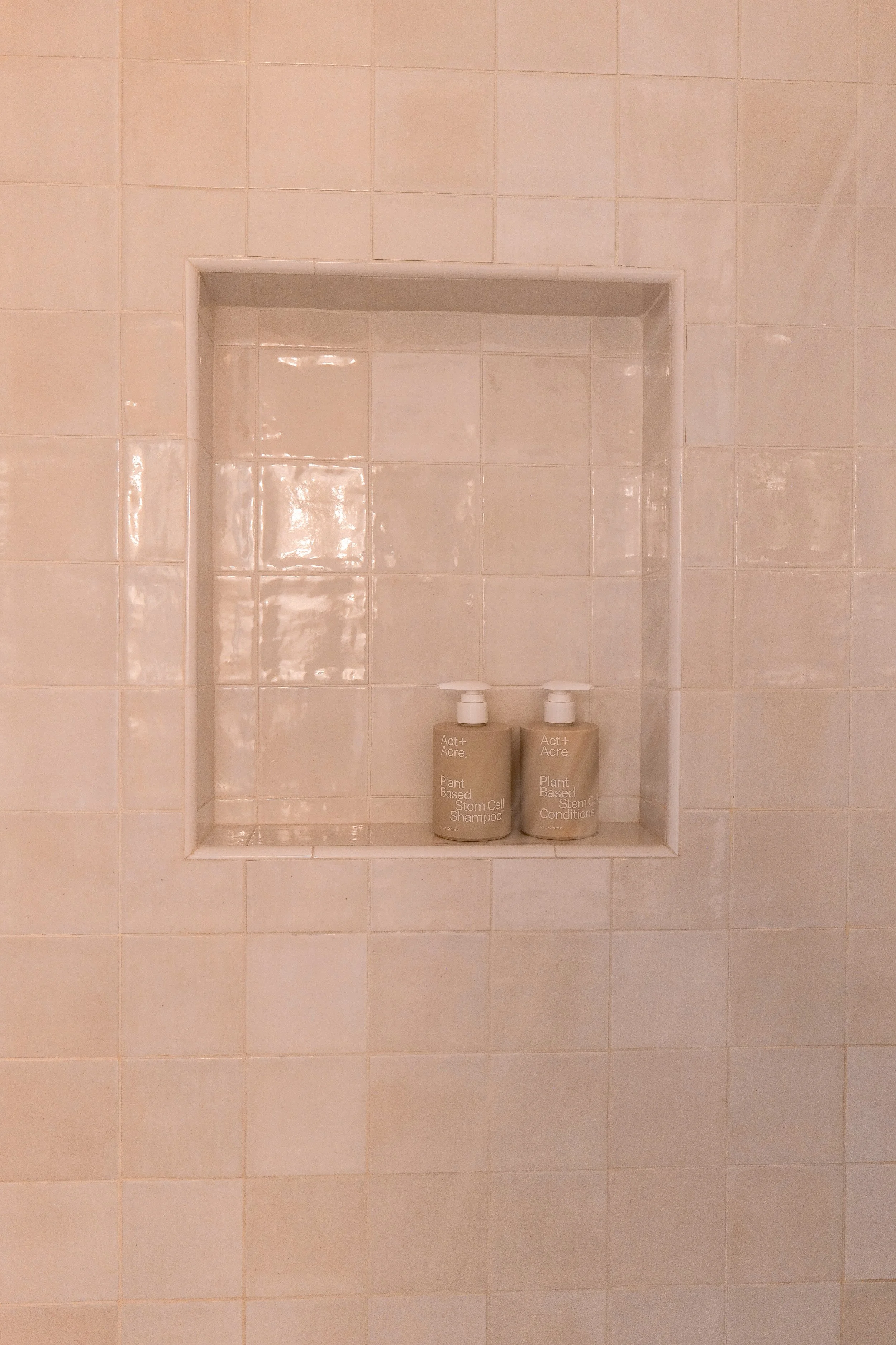 Close-up of the shower tile and faucet in our remodeled coastal bathroom.