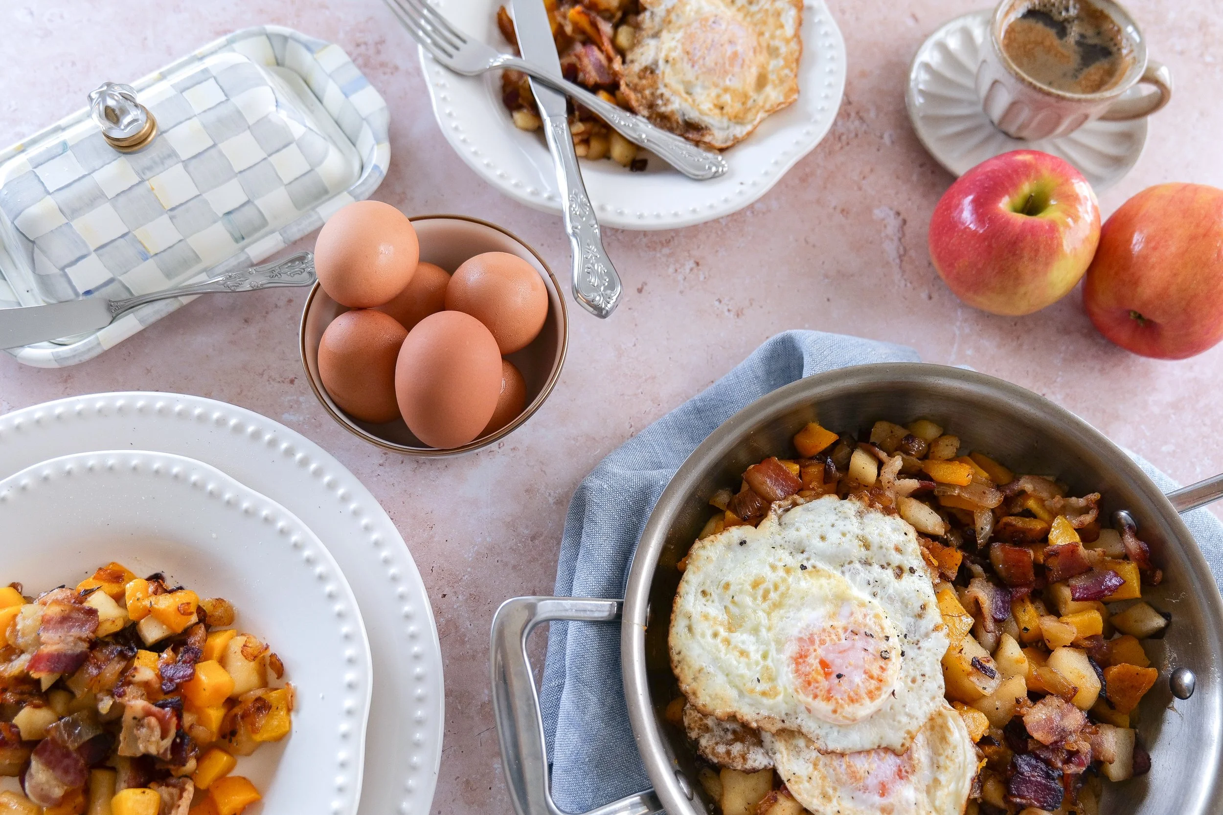 Butternut squash bacon and egg hash served warm for a hearty breakfast or brunch.