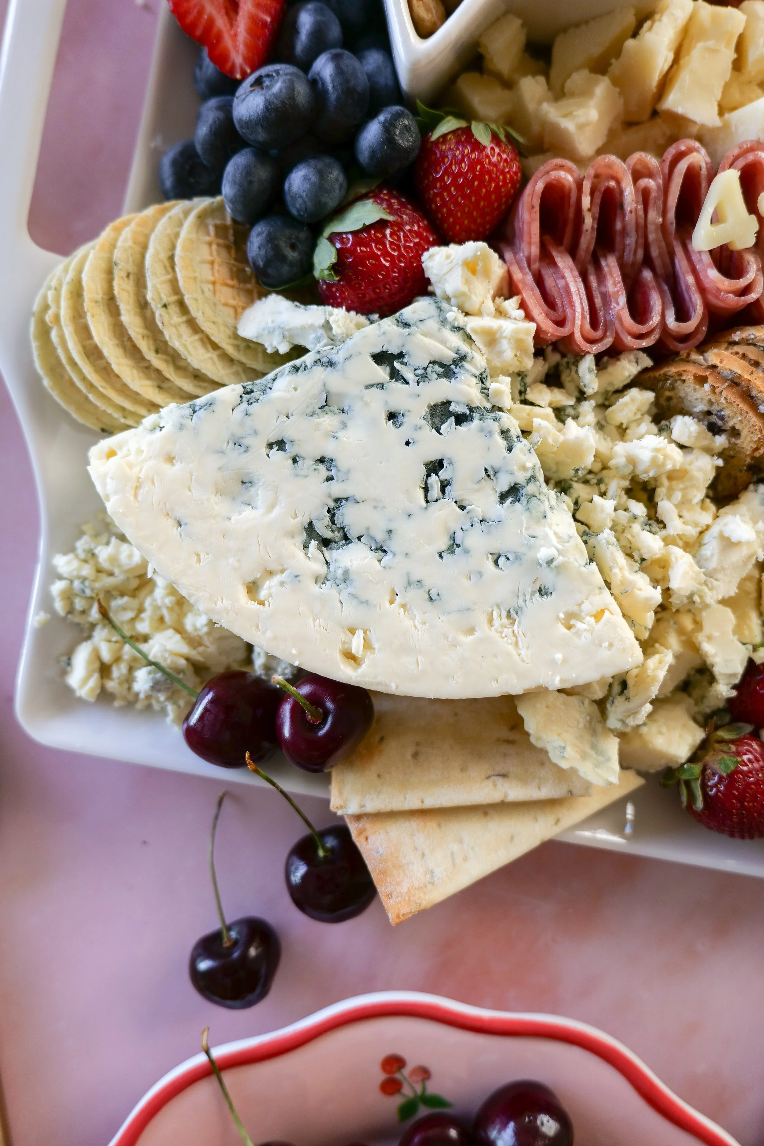 Patriotic entertaining ideas featuring an easy red, white, and blue charcuterie board.