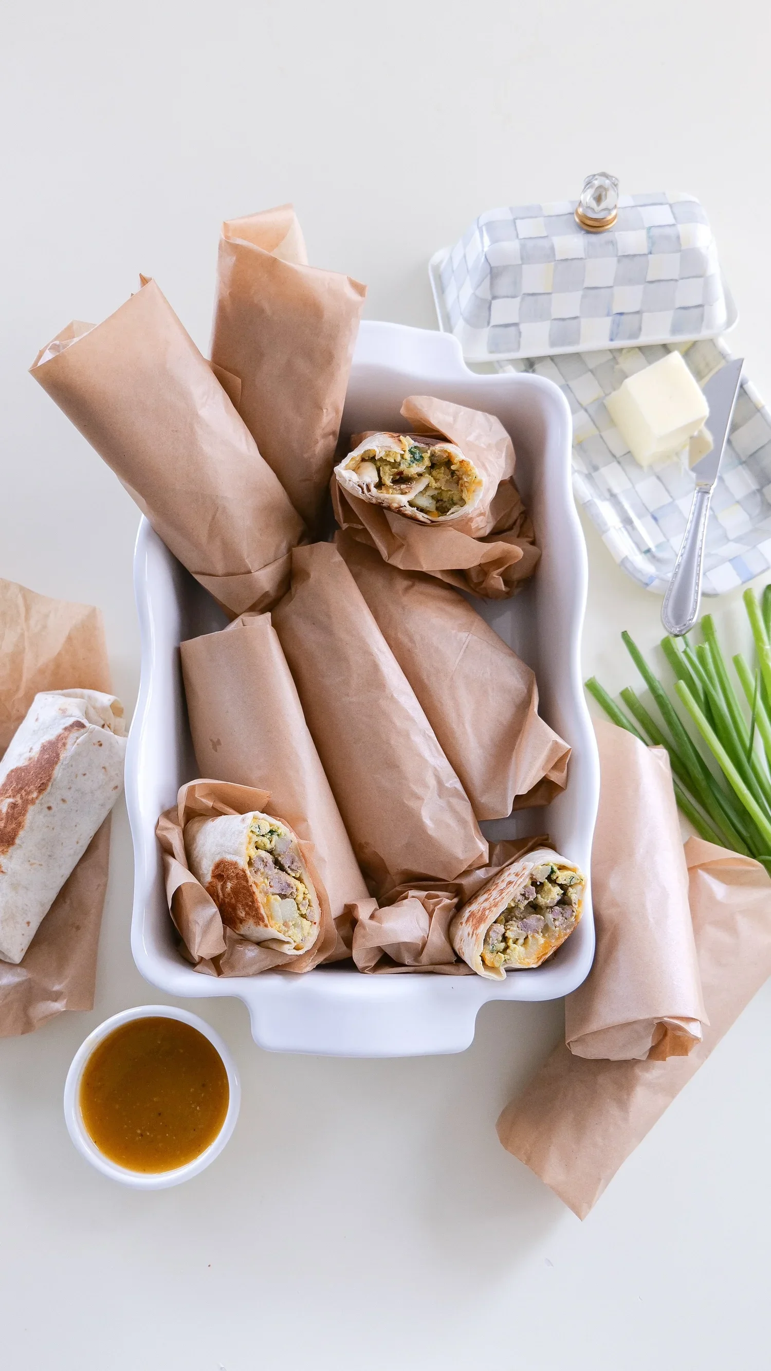 Sausage, spinach, potato and egg breakfast burritos prepared for the freezer.