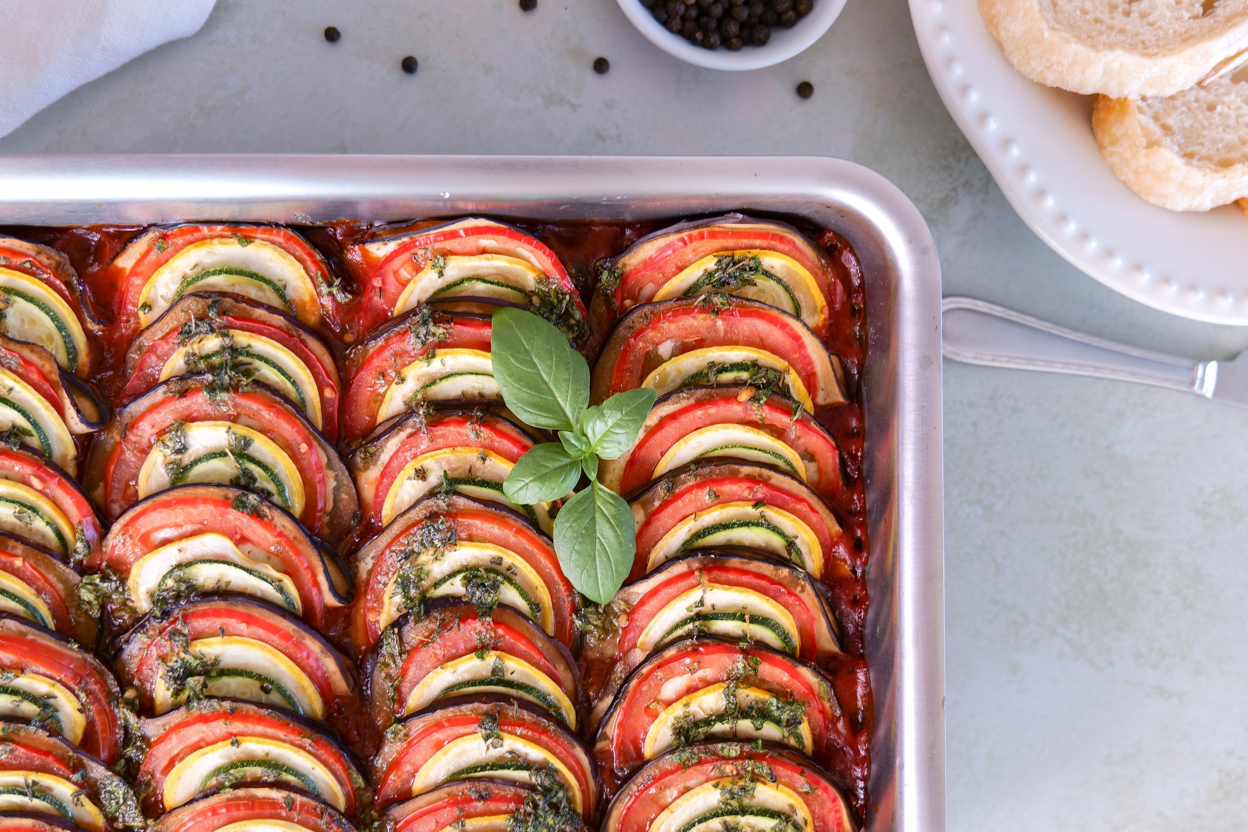 Close-up of classic ratatouille with tender vegetables and fresh herbs.