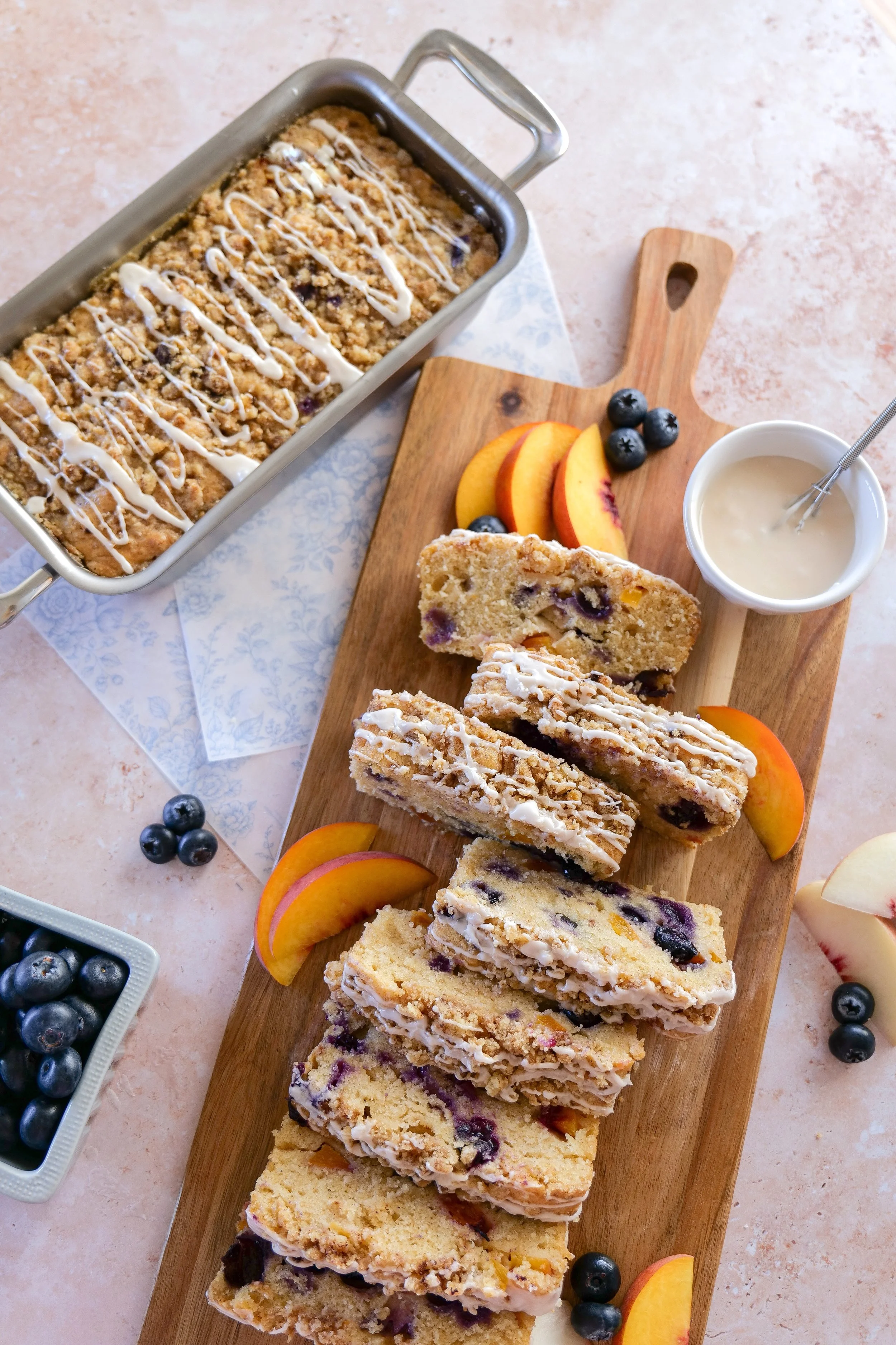 Freshly baked Blueberry Peach Bread with golden cinnamon streusel cooling on a wire rack.