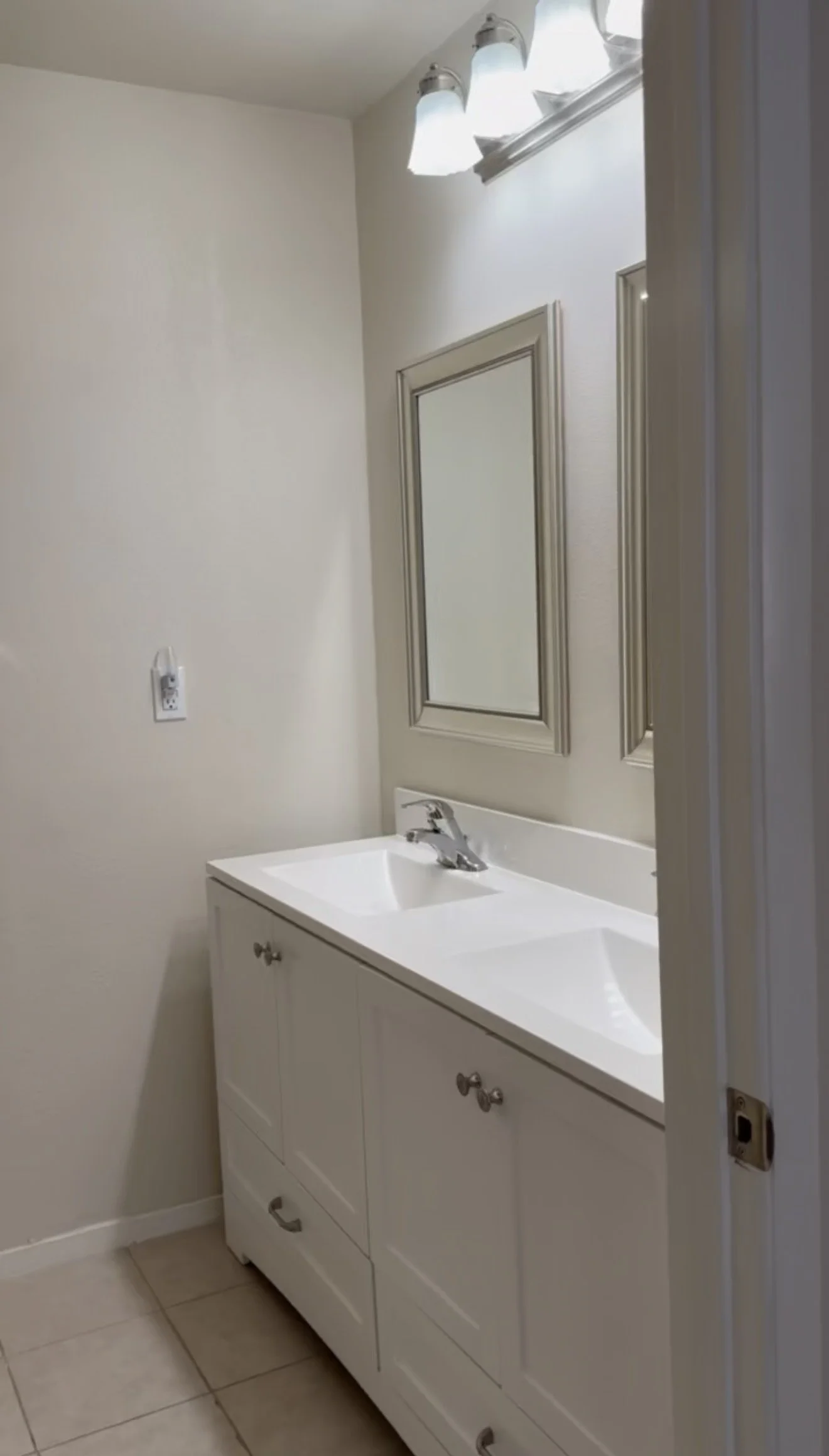 Bathroom before the remodel, showing the original vanity and dated shower.