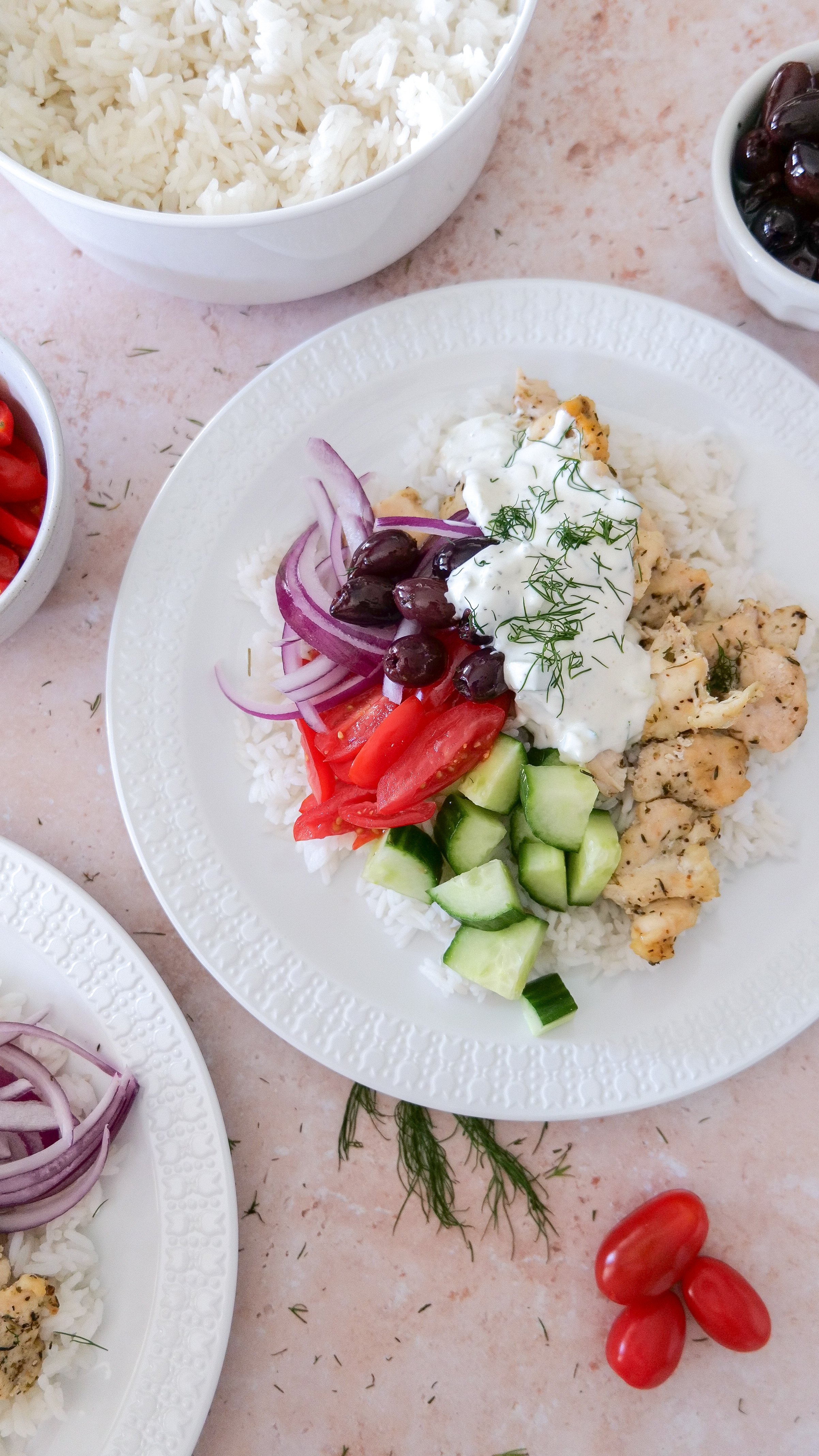 Greek chicken bowl with cucumber, cherry tomatoes, red onion, Kalamata olives and homemade tzatziki.