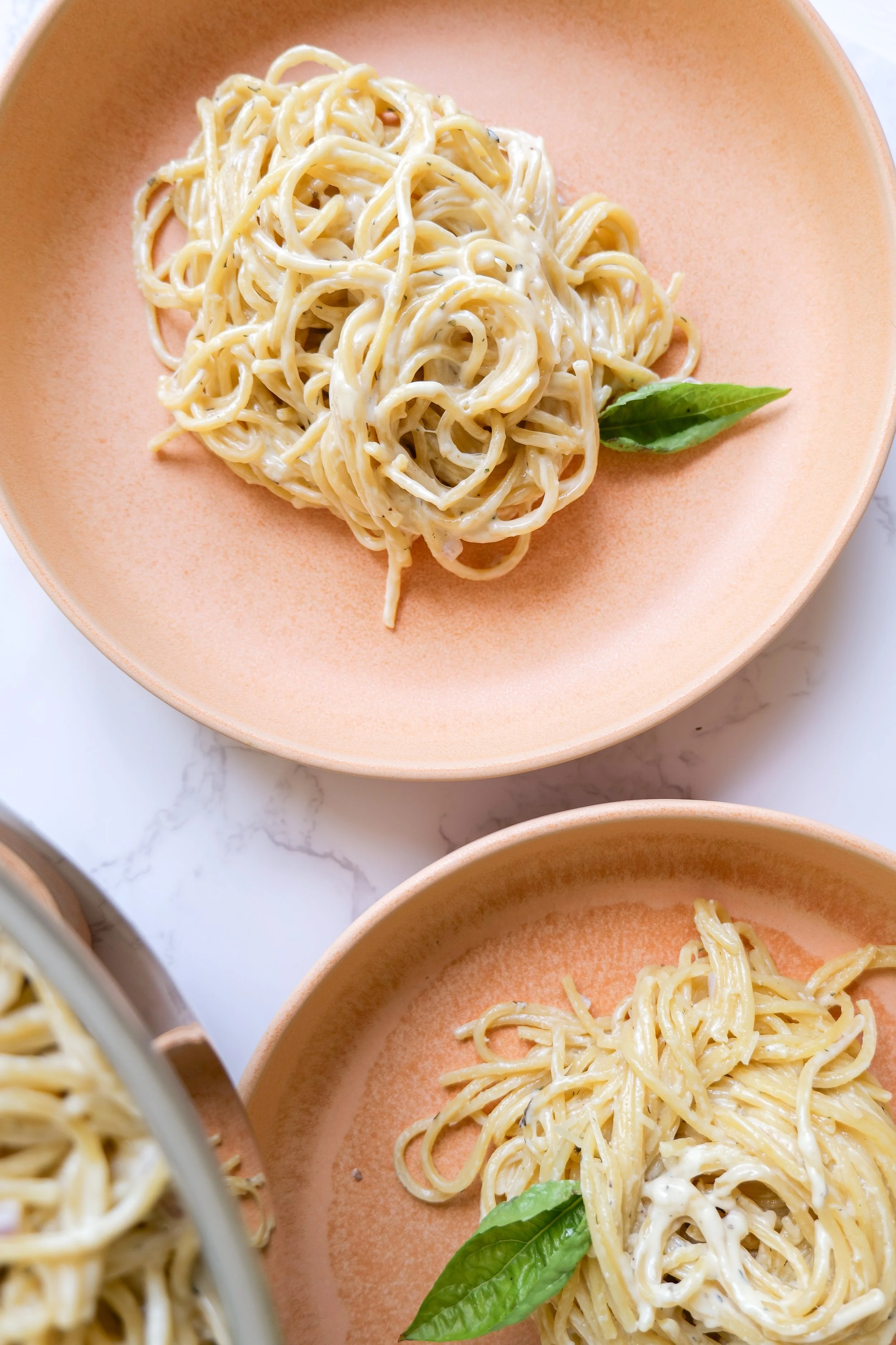Homemade white sauce tossed with pasta and topped with Parmesan.