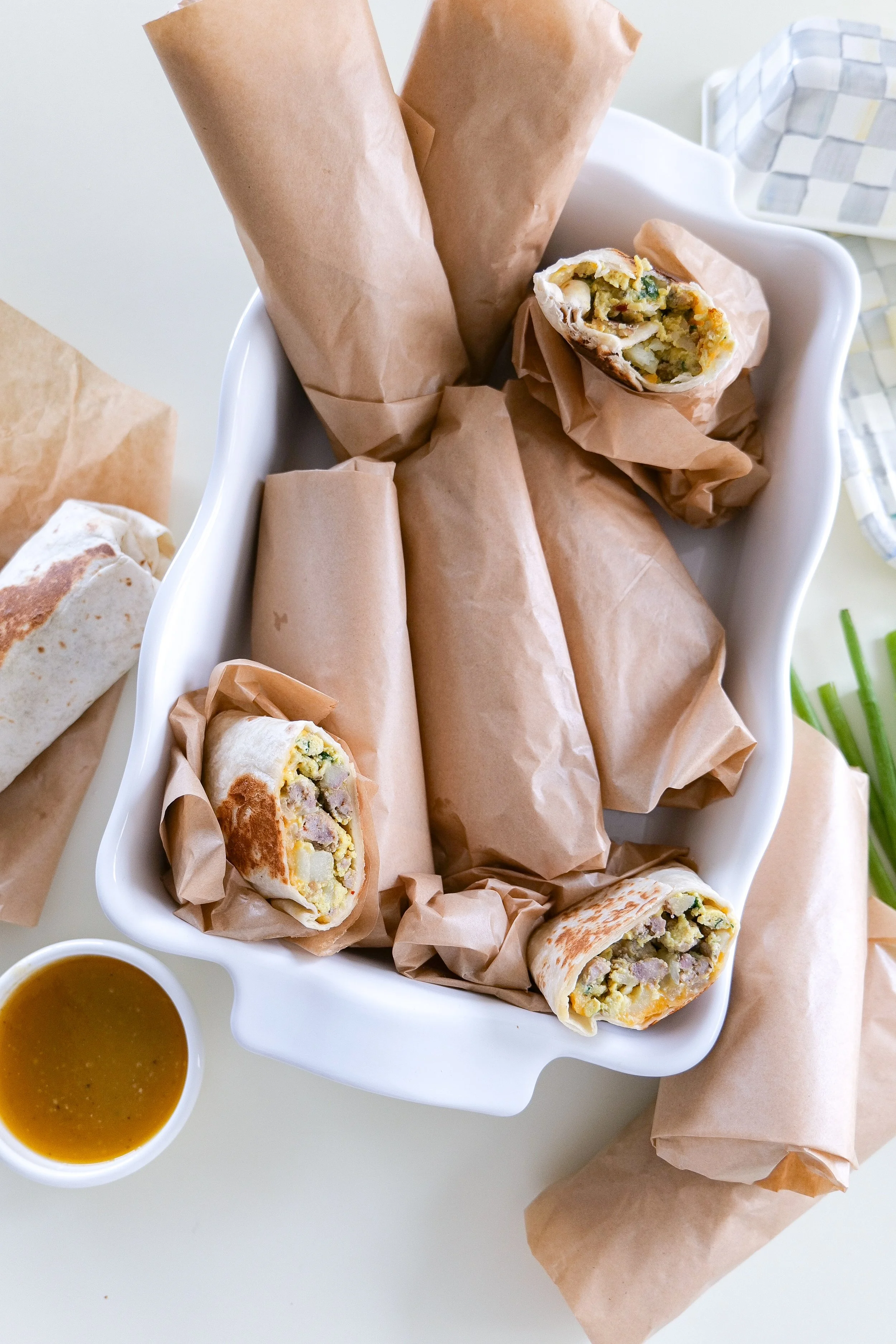 Sausage breakfast burritos made ahead with eggs, crispy potatoes, spinach and Colby Jack cheese.