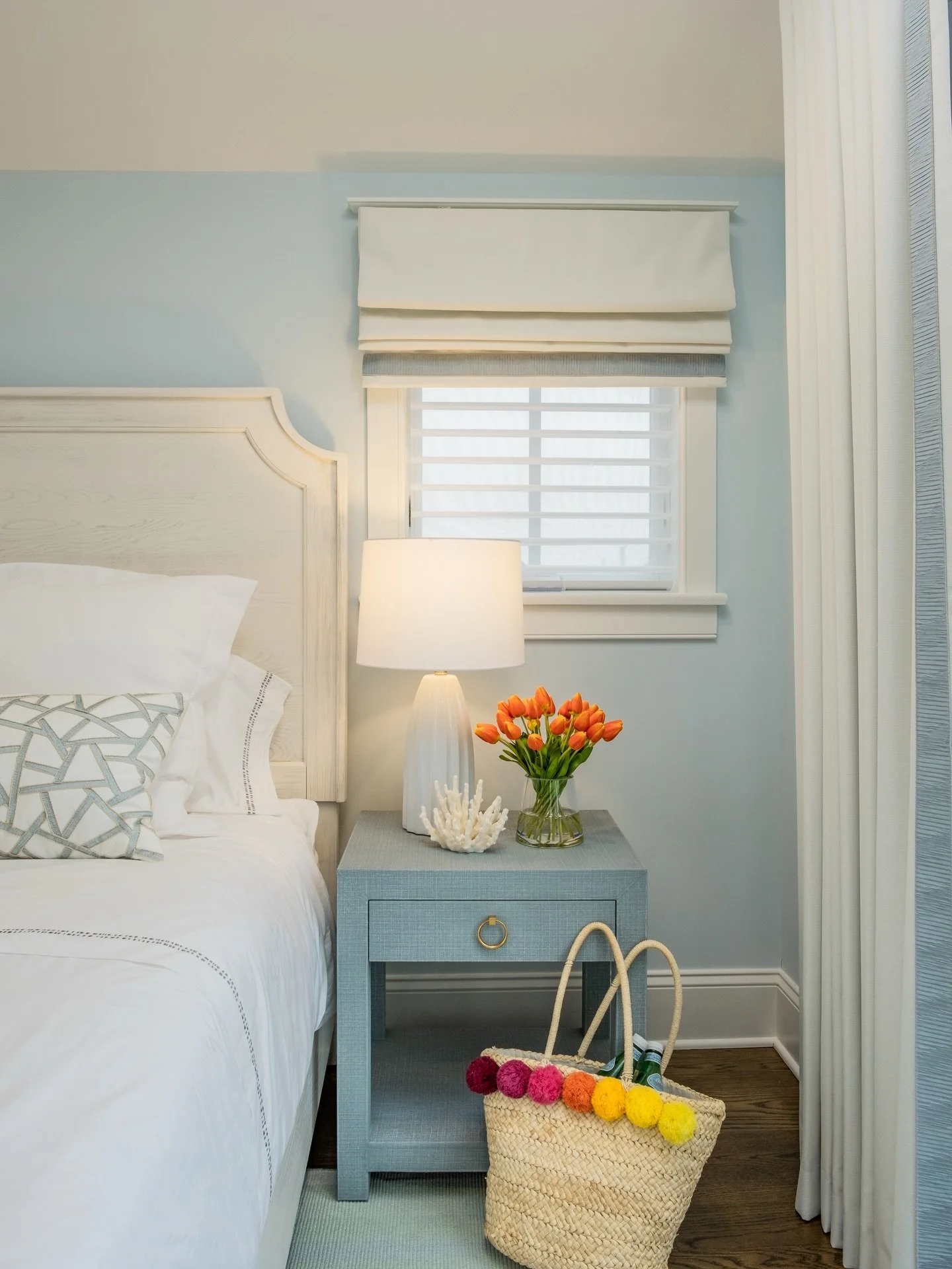 This bedside moment is all about layering texture and tone. Grasscloth, tailored linens, woven fibers, and a hint of brass for warmth. The coral detail and fresh tulips bring just enough personality to keep it feeling light, coastal, and effortlessly