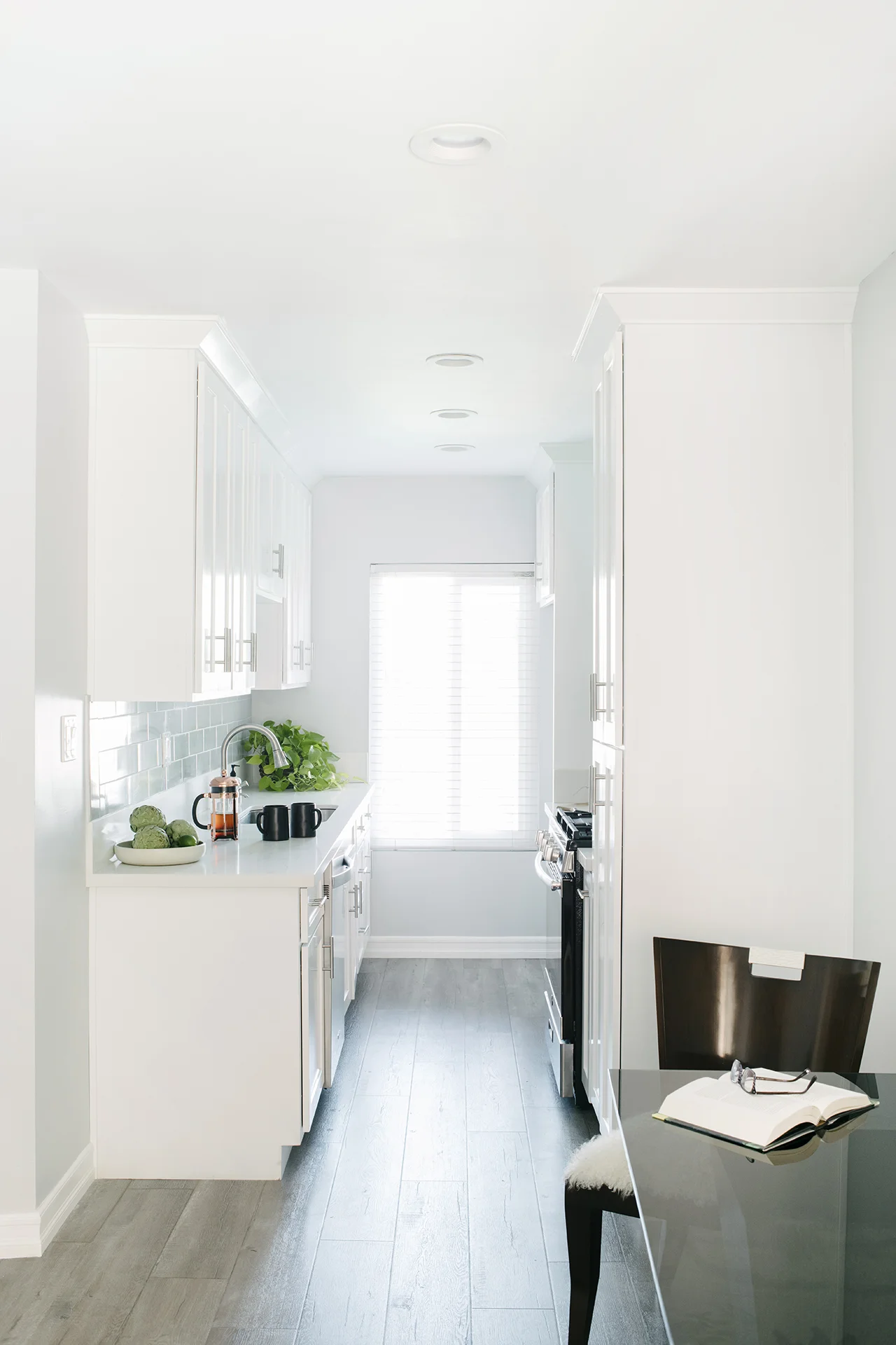 Renovated kitchen with stainless steel appliances and white cabinets in Redondo Beach apartment complex