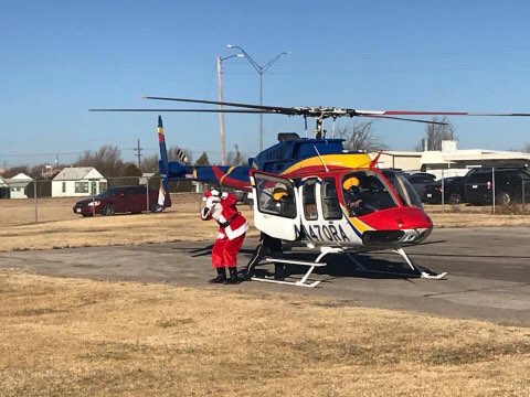 Santa arrives to the Northside Toy Drive Toy Giveaway in a helicopter courtesy of Rico Aviation.
