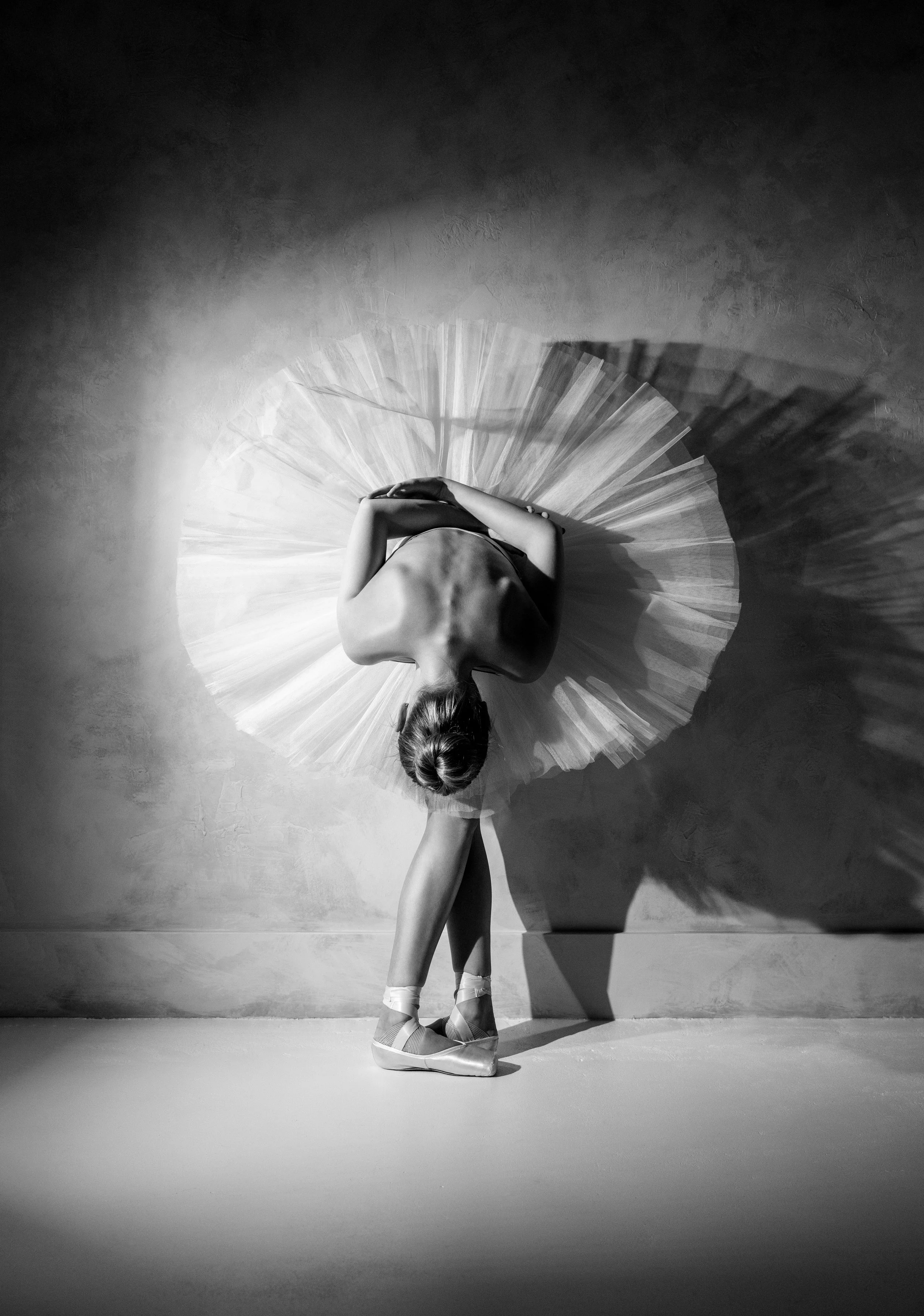 Black and white ballet portrait with sculptural shadow and movement