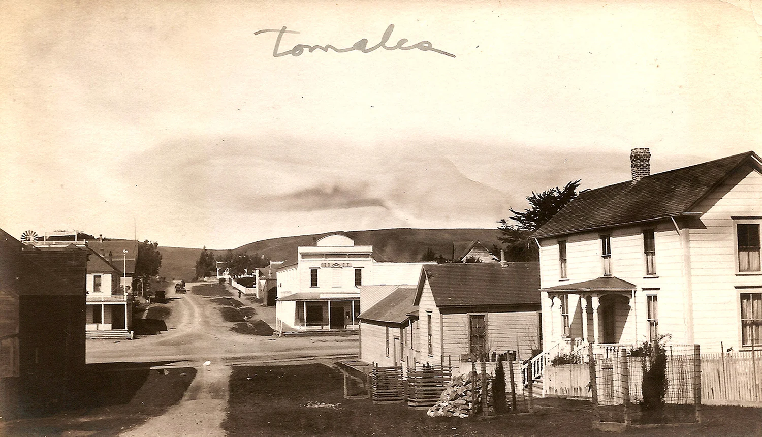 A view west from First Street across Highway One, Upper Town Tomales’s main intersection, a few years before a large fire destroyed sixteen buildings, including the hotel on the corner, one just visible behind it, and the livery stable in shadow, all at left. Photo by Ella Jorgensen circa 1916.