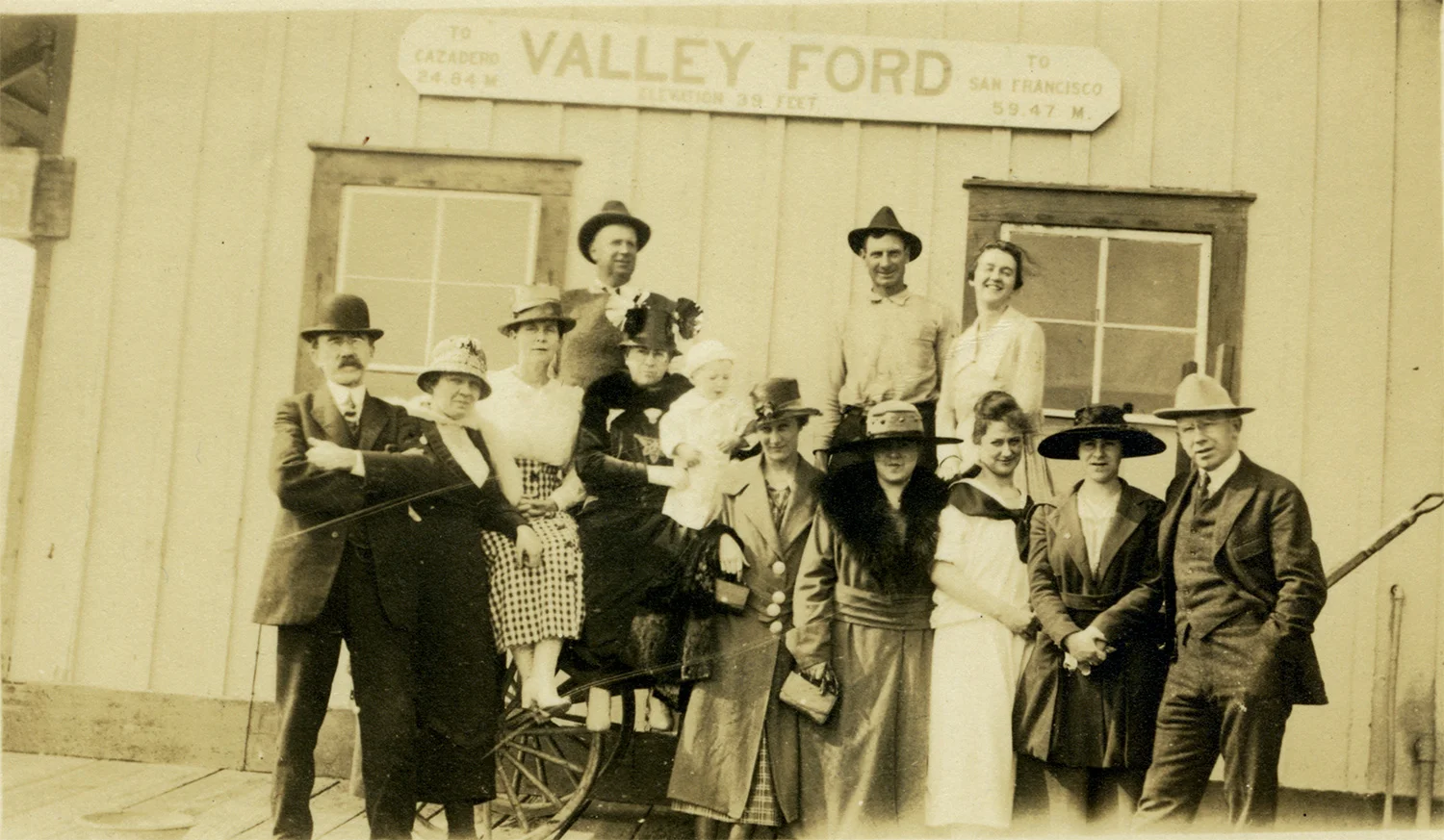 A well-dressed crowd poses at the Valley Ford railroad depot, circa early 20th century.
