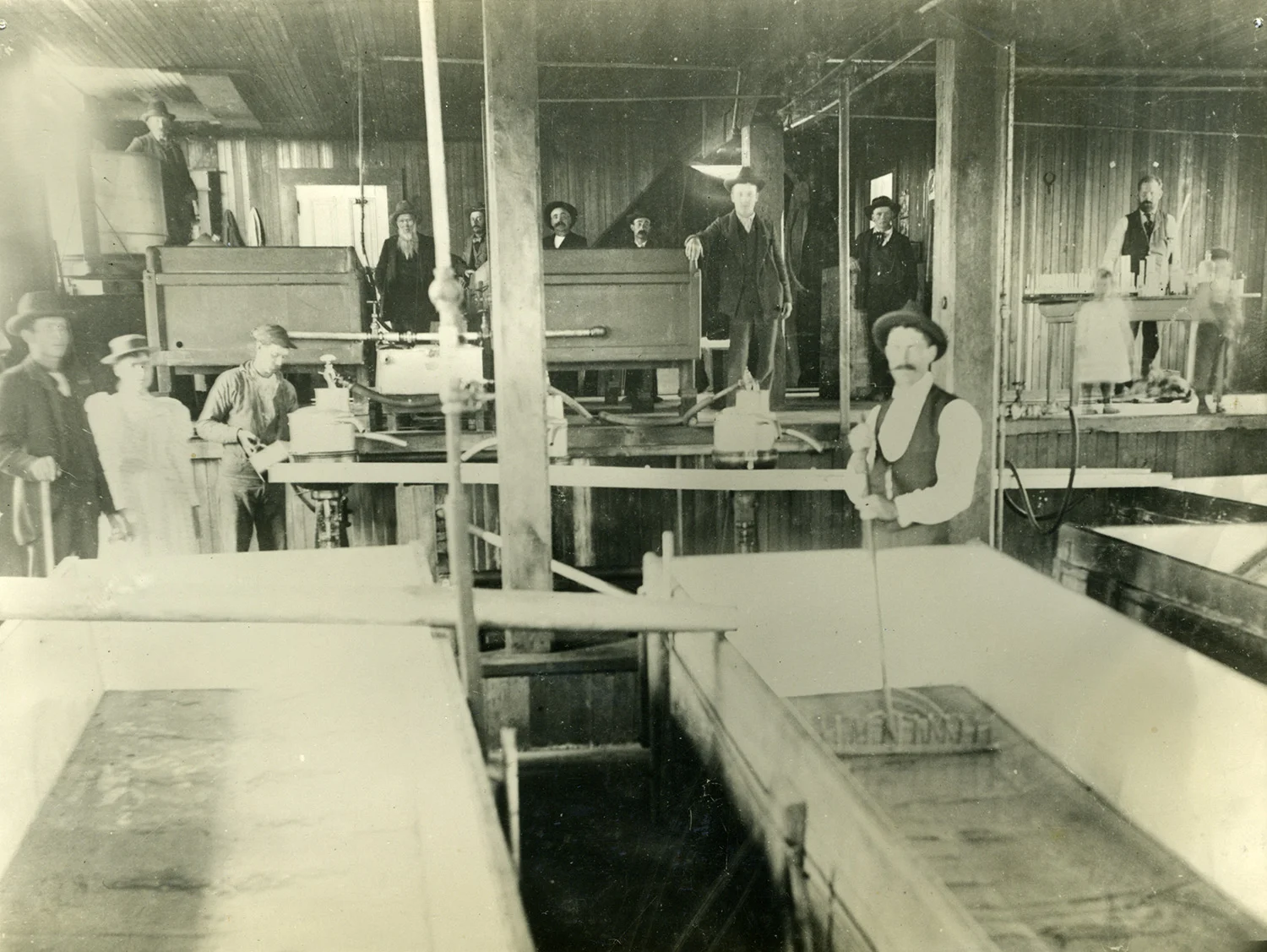 Interior of the Fallon Creamery, one of the region’s largest creamery operations, with owners, workers, and probably some family members, circa 1900.