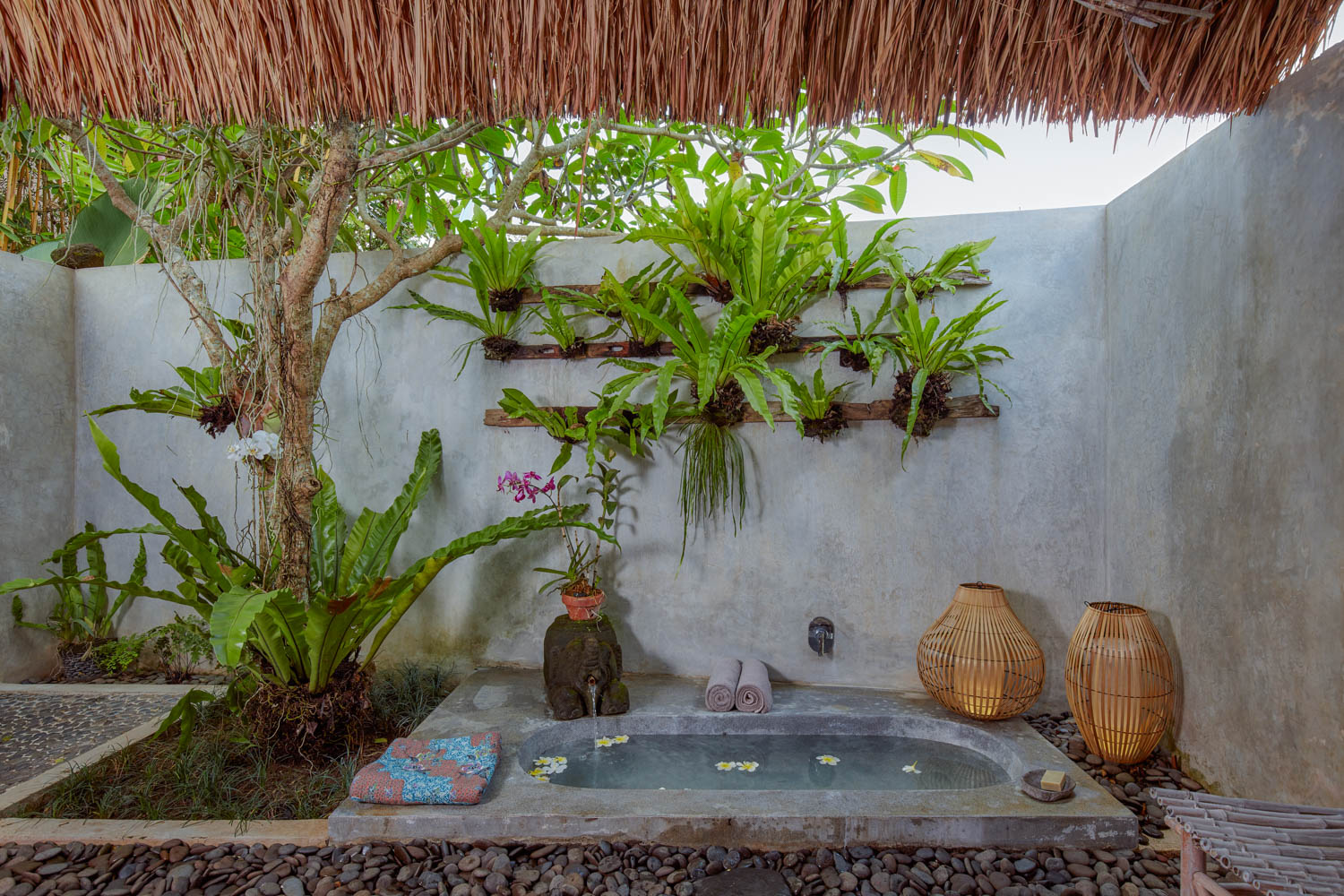 open air bathroom with sunken terrazo tub