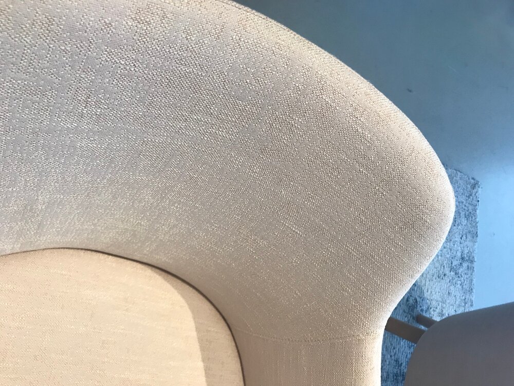  The rounded seat pan of this chair is amplified outward by the wrap-around back. The slight color variation in the two piece’s upholstery brings attention to this detail. 