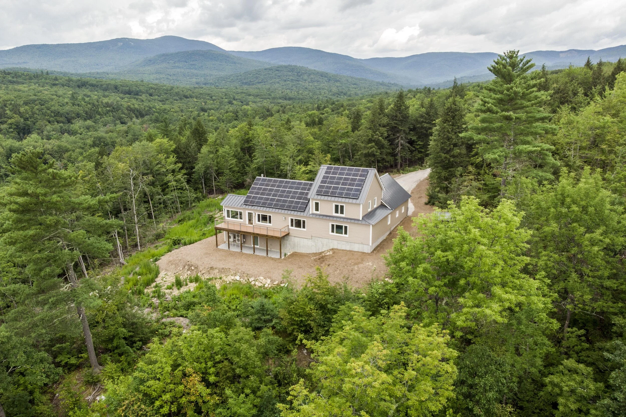 A hilltop site overlooking Kezar Lake in western Maine proved the perfect spot for a home assembled from prefabricated parts. Thanks to a 15 kW solar array, the building should generate more power than it consumes on an annual basis.