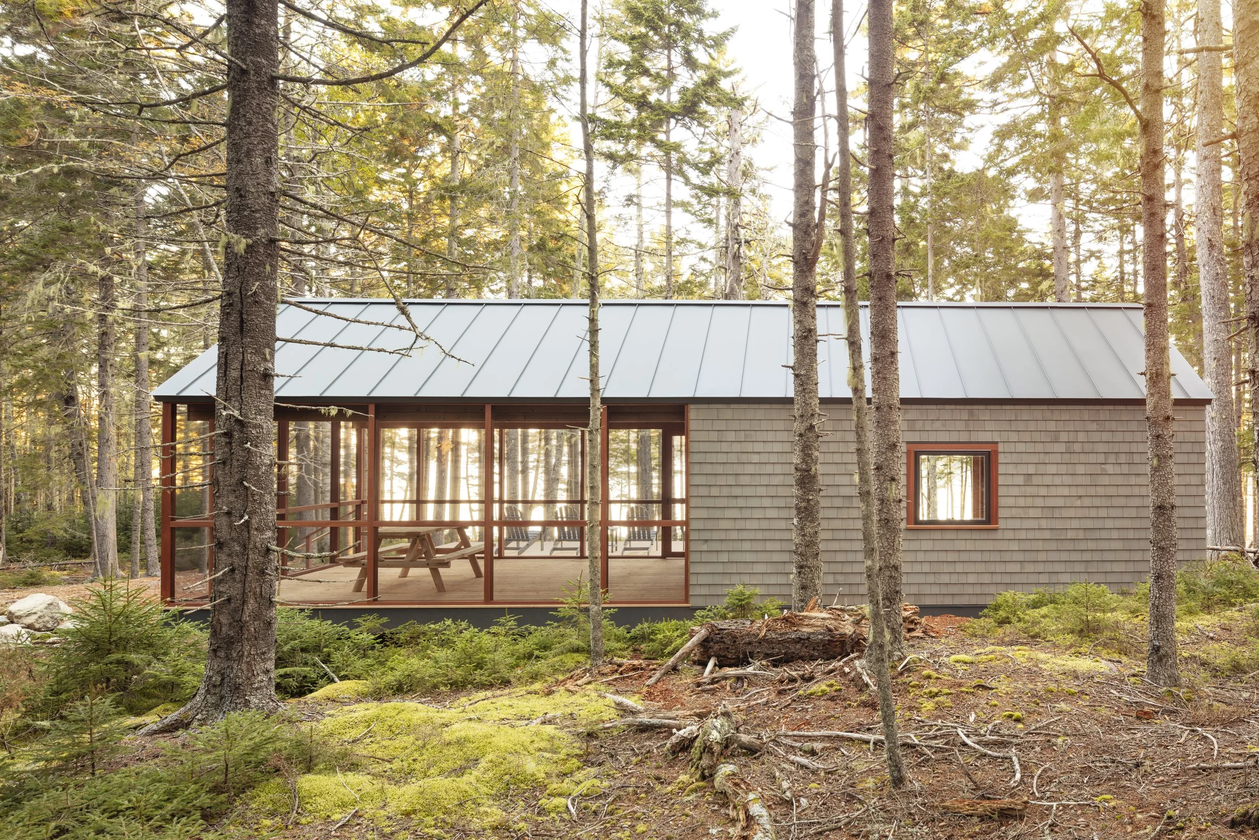  With floor-to-ceiling screens on three sides, the boathouse porch admits abundant light and air, but no unwanted insects, ensuring convivial, peaceful meals. Outside, Adirondack-style chairs invite you to settle in and watch the endlessly changing b