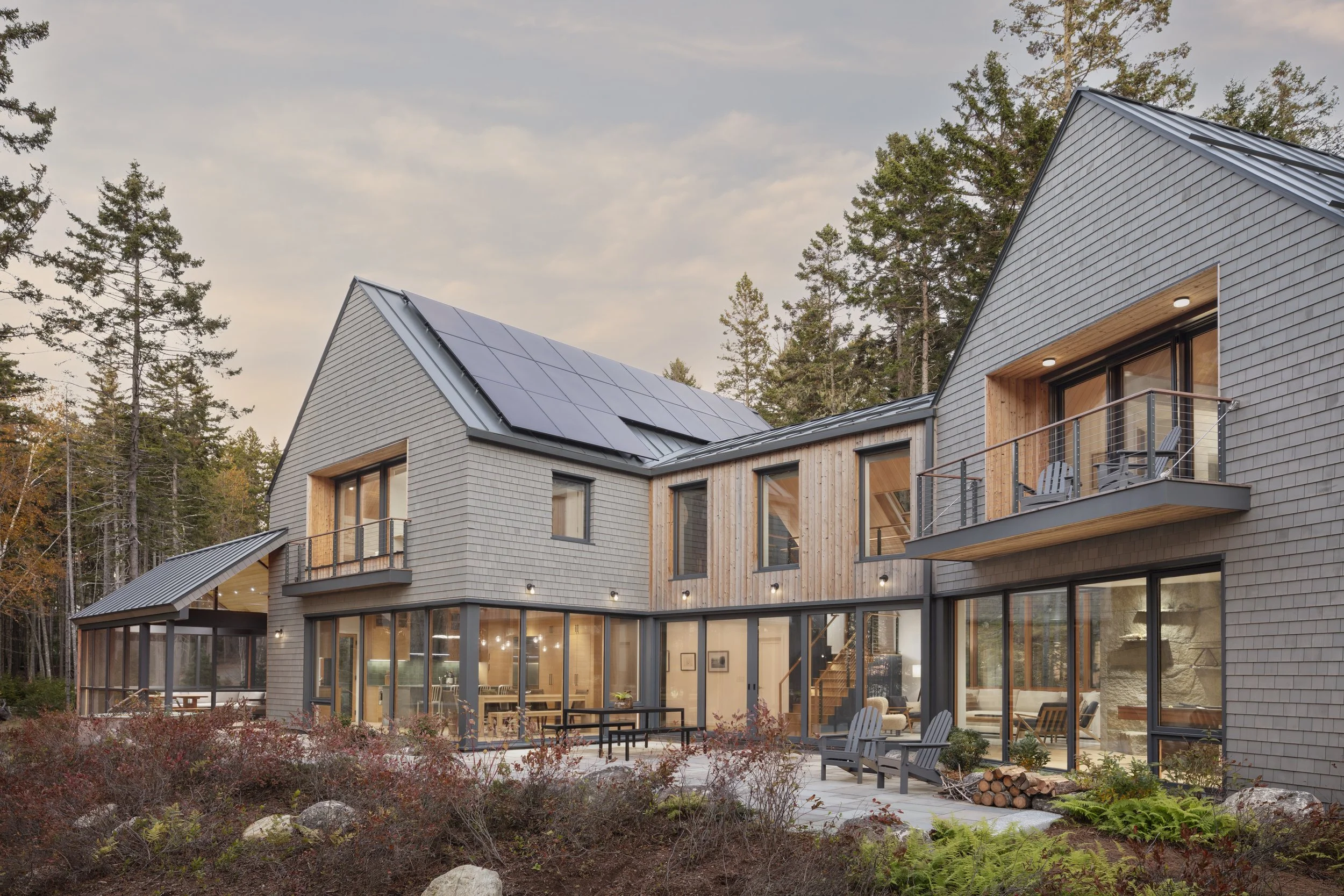  The guest wing on the upper left side houses two bedrooms, a four-bed bunk room, an office, balcony and bath. The primary suite on the upper right contains a bedroom, bathroom, walk-in closet and large balcony. Between them is an elevated bridge des
