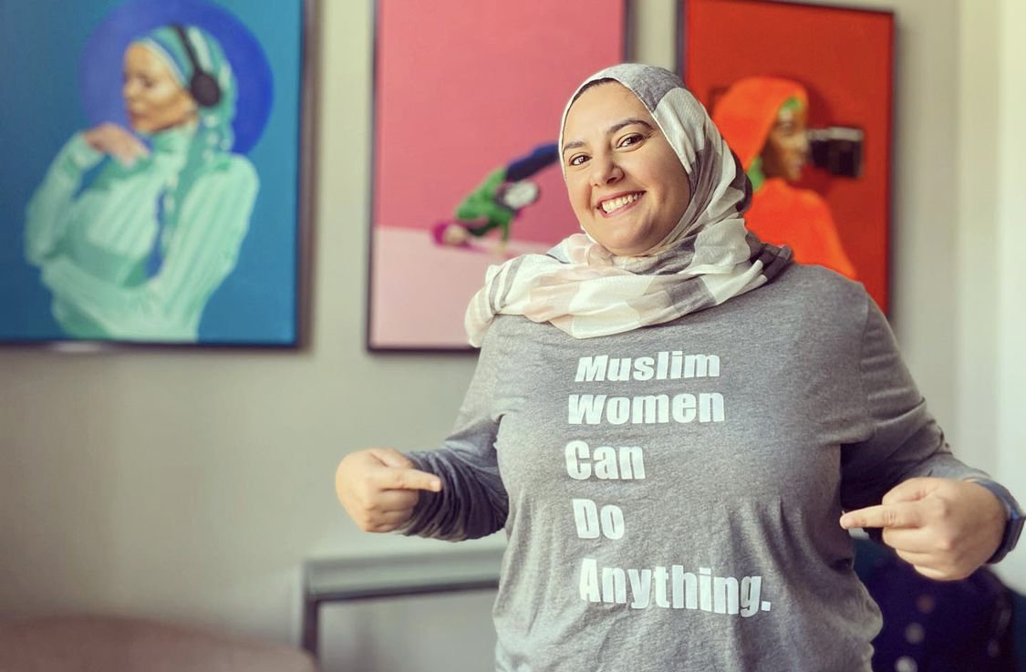 Iman pointing a shirt, _ Muslim Women can do anything_.jpeg