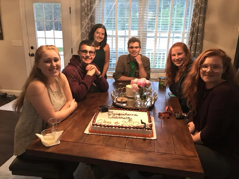 students gather for an event to celebrate their college attendance