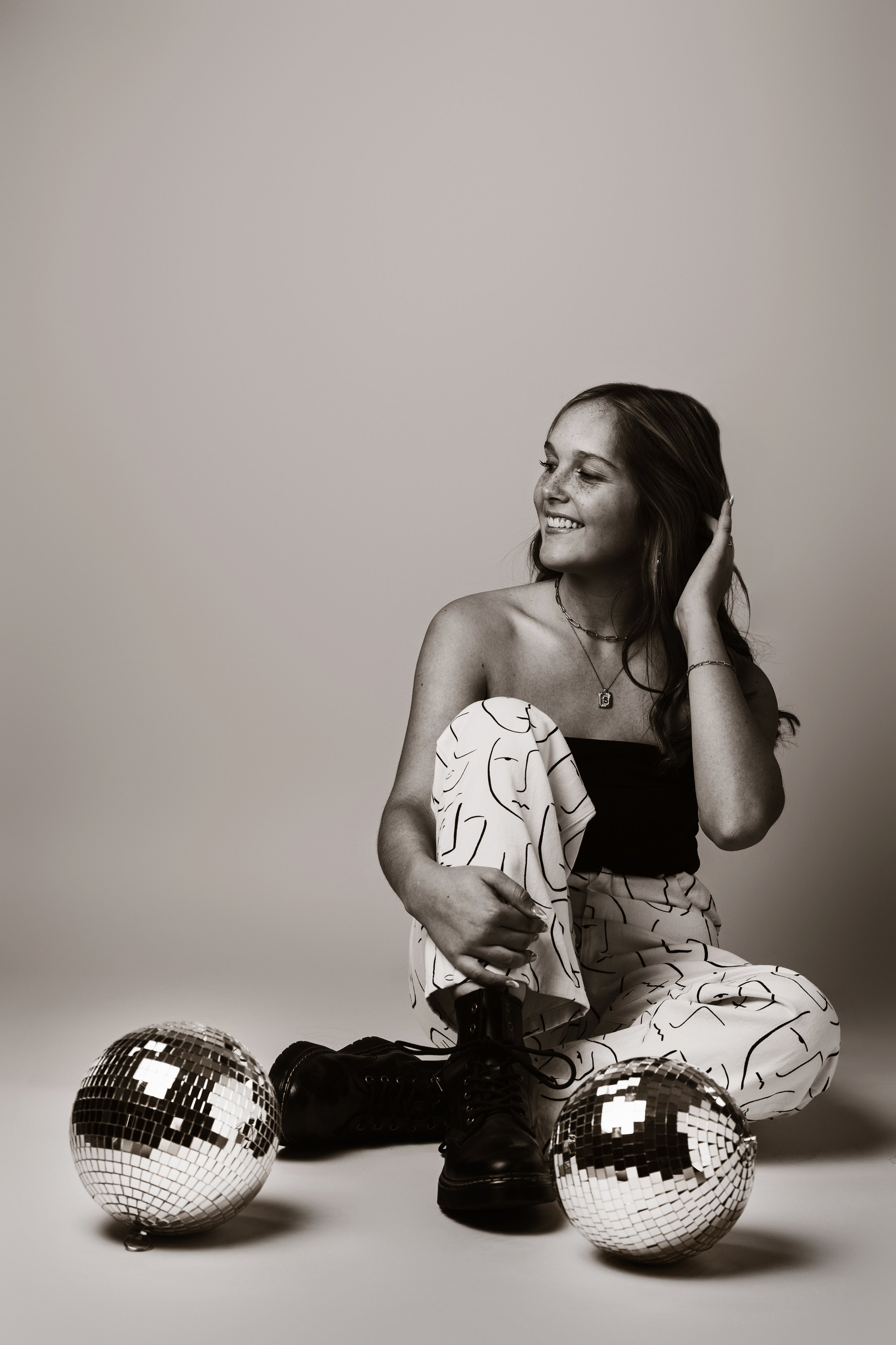 Fun styled Senior Girl Portrait in Studio with disco balls.