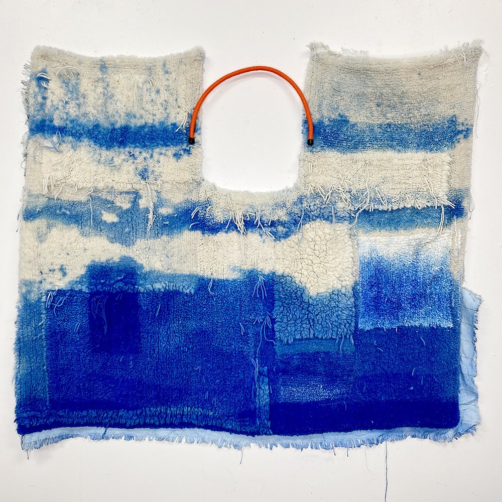    Poncho de Sancho . Wool, polyester, acid dye, nylon, rubber. 40” x 39”. 2022 