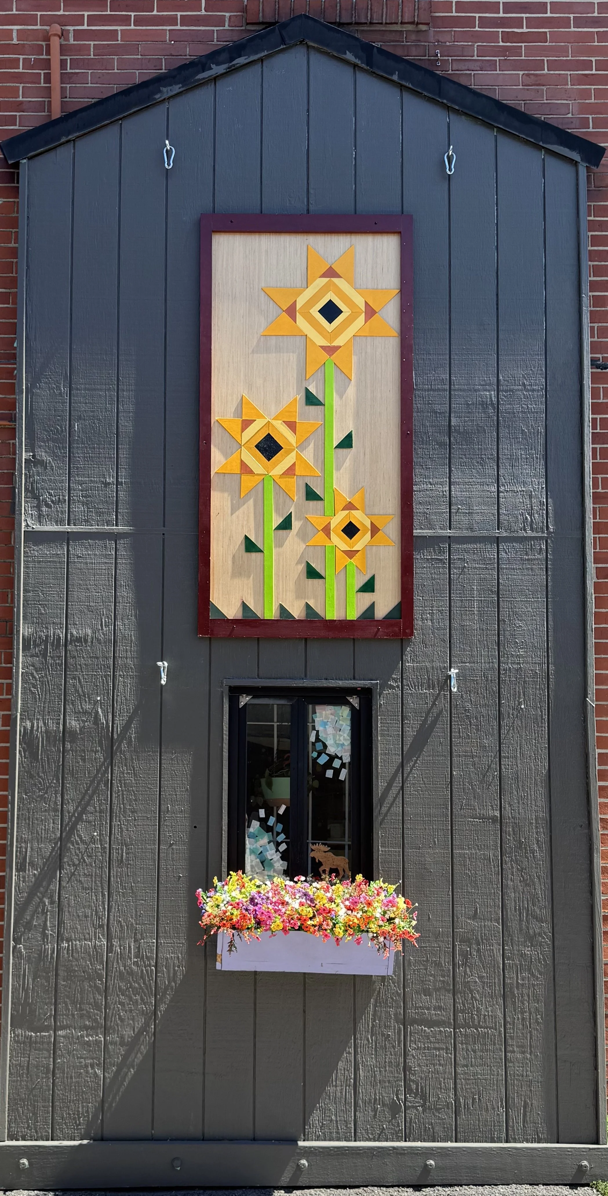 Artwork hung is built in the traditional barn quilt style by Jim Liggett.