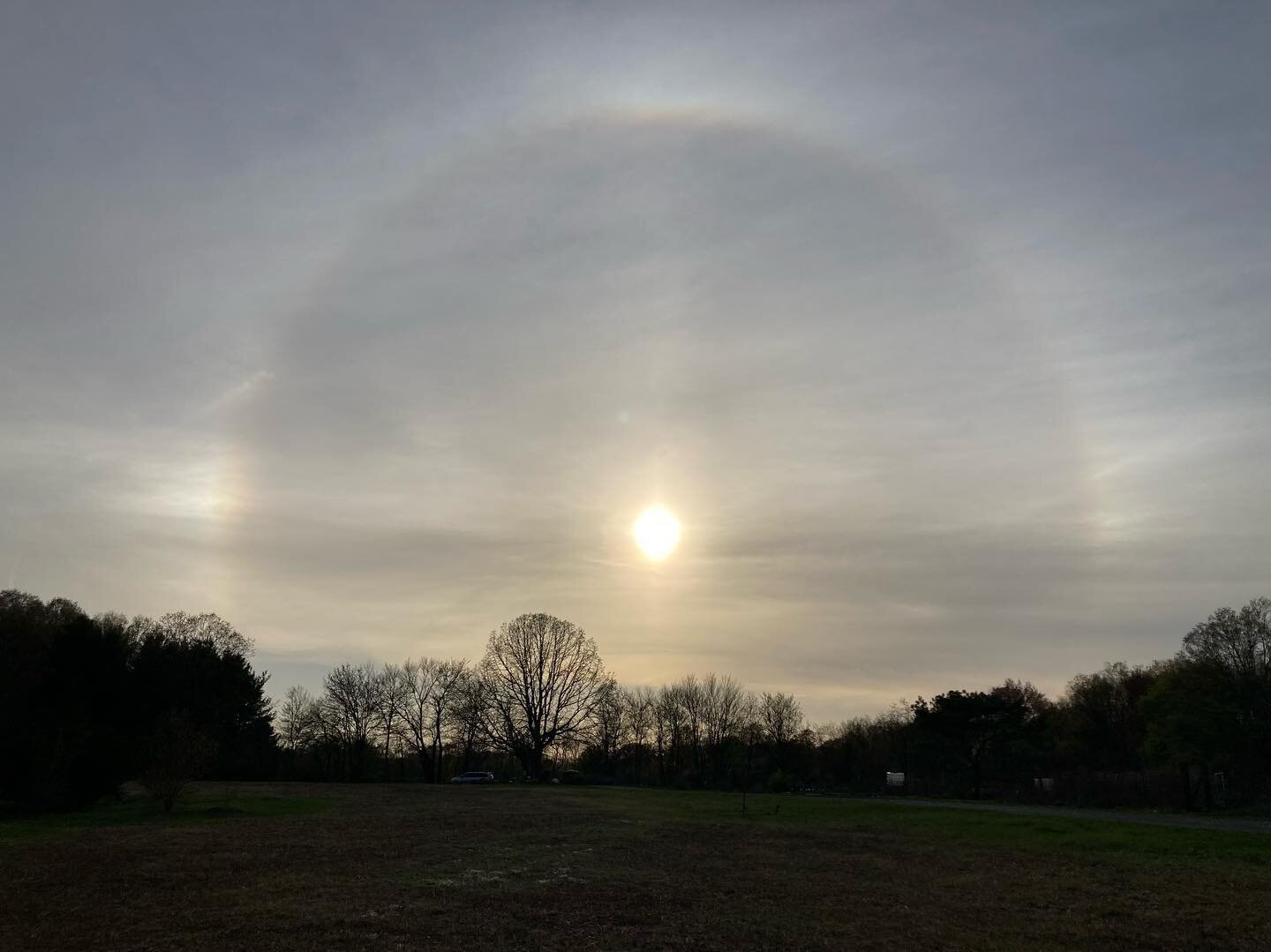 Observed solar halo with sun dogs (parhelia). 
&hellip;
A sun halo is an atmospheric phenomena wherein a 22&deg; luminous circle is visible around the sun. It is formed when hexagonal ice crystals are suspended in high atmosphere cirrostratus clouds 