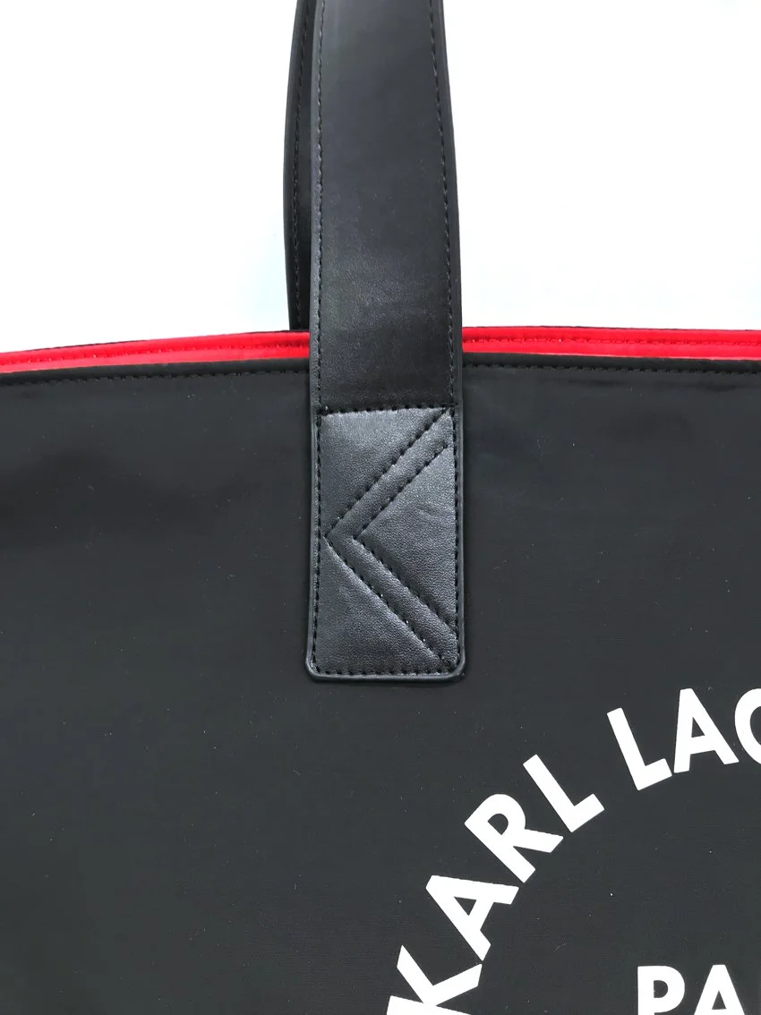  Detail of the handle attachment of a tote bag made with nylon and vegan leather.  Made for  CWF© (Karl Lagerfeld Kids®)  