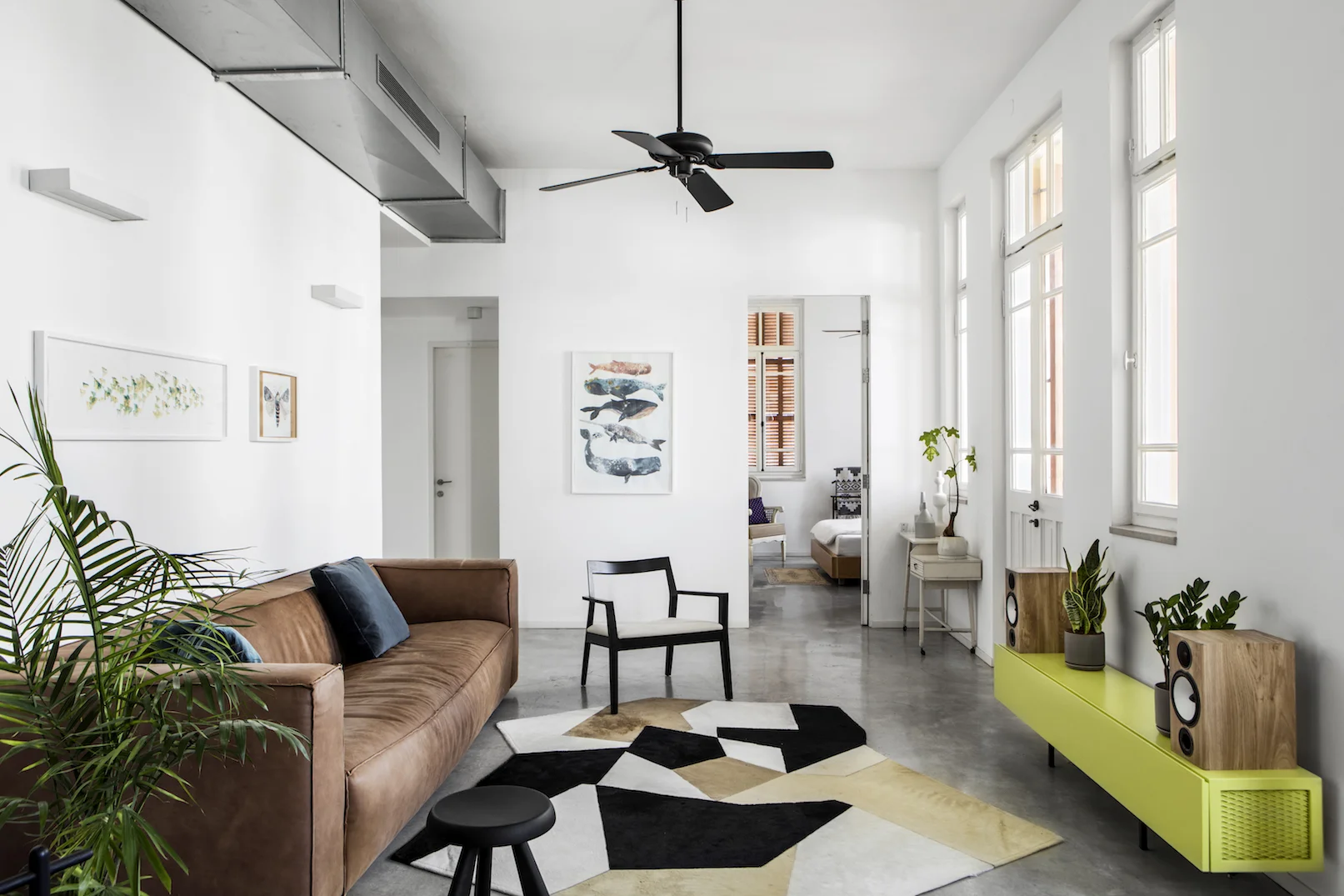 An apartment renovation in an old preserved building next to the Carmel market. In the most hectic area in Tel Aviv this home was meant to serve as a serene haven. Clean lines, concrete floors and bare materials compliment the high ceiling and large