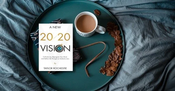 A copy of A New 20/20 Vision sits on a tray next to coffee.