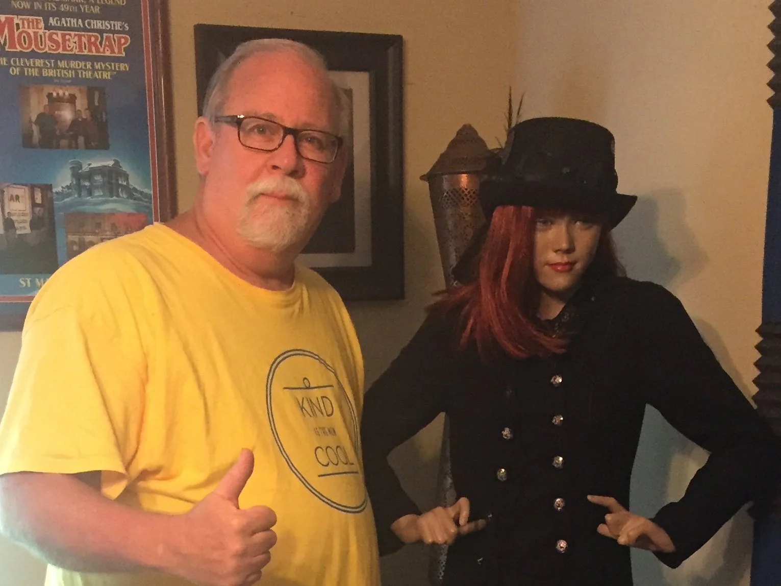 Man standing beside a steampunk mannequin in a recording studio.