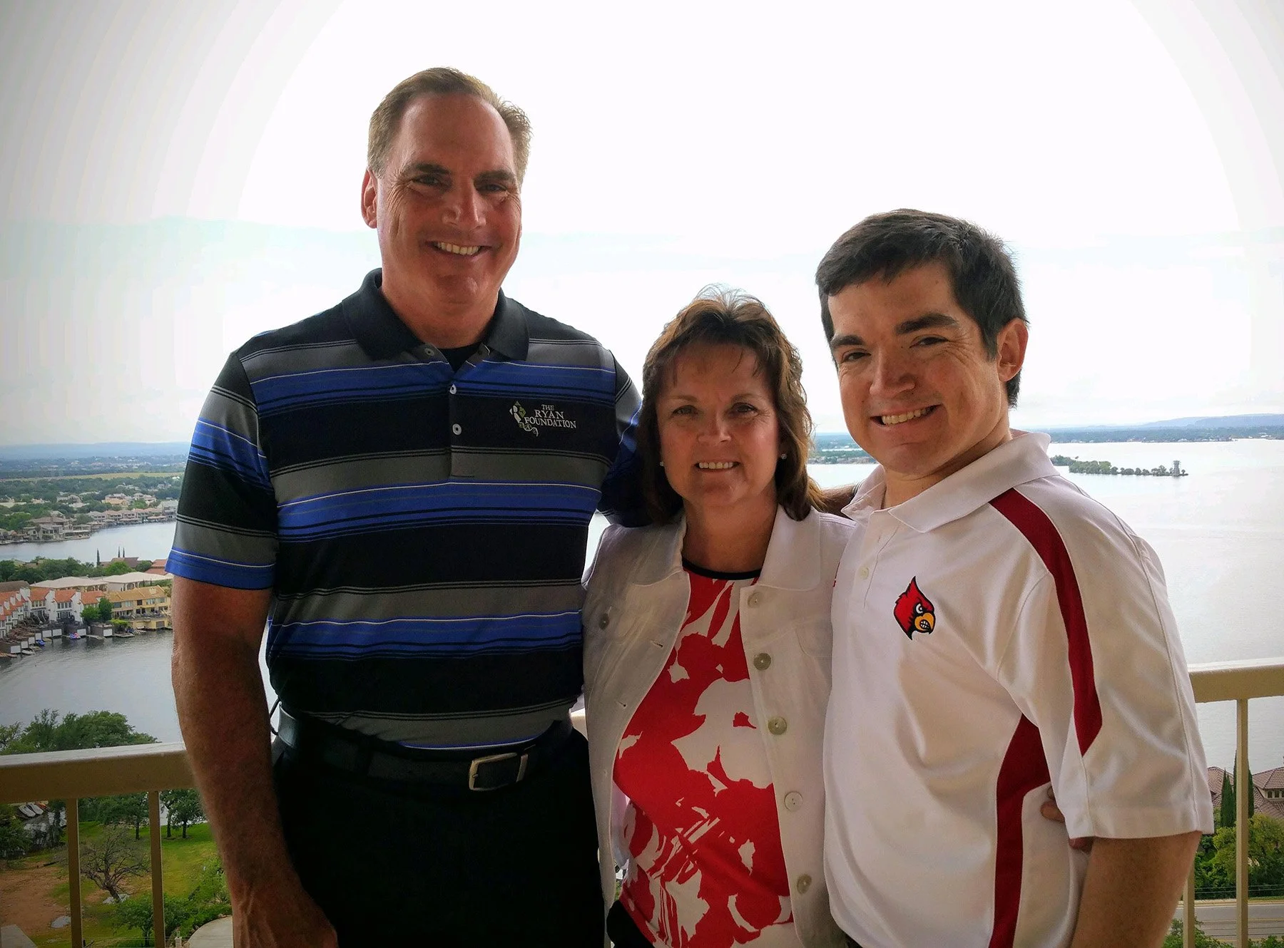 Family portrait overlooking a lake, celebrating years of resilience and progress.