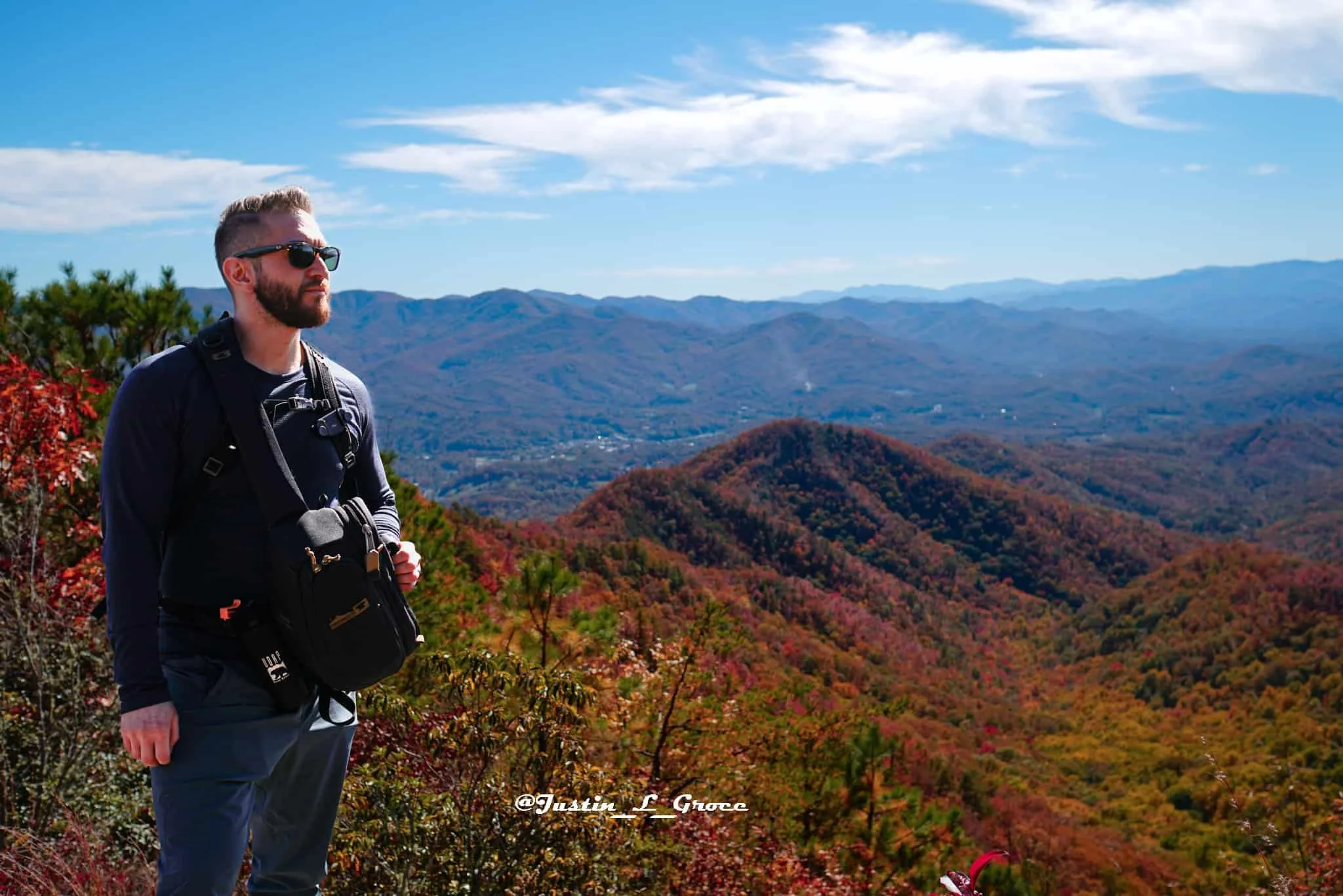 Man standing in the colorful fall foilage in the Smoky Mountain, Bryson City.