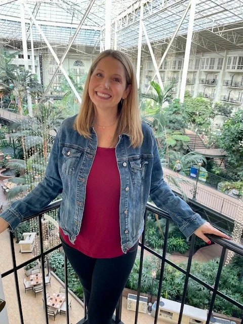 Woman surrounded by greenery inside the Gaylord Opryland Hotel.