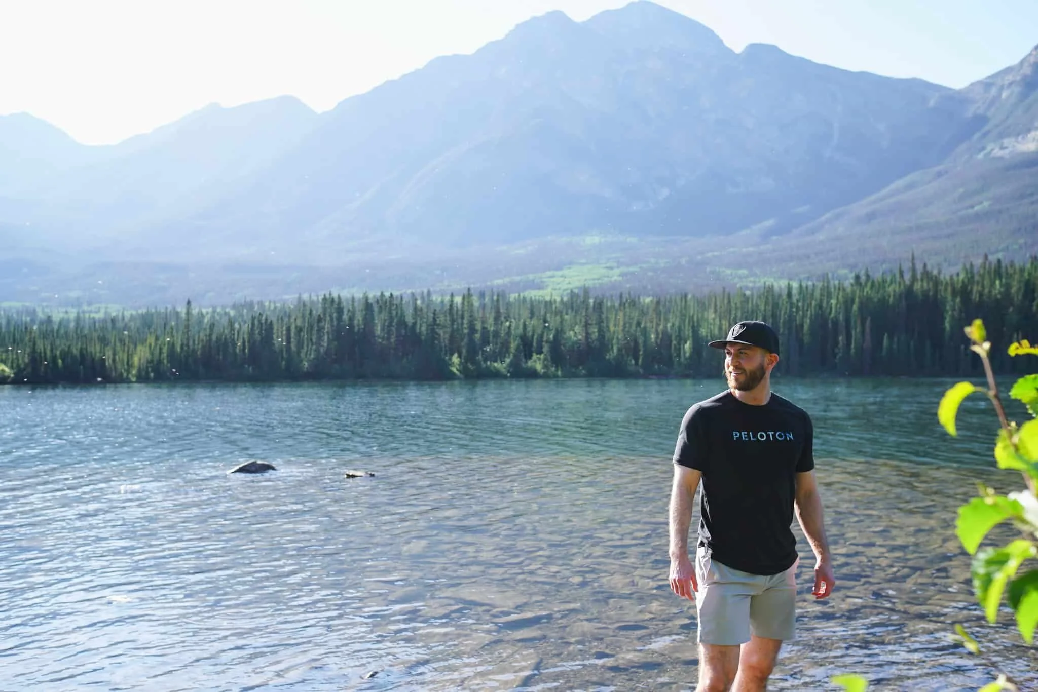 Man standing in front of Pyramid Lake with Pyramid Mountain in the background