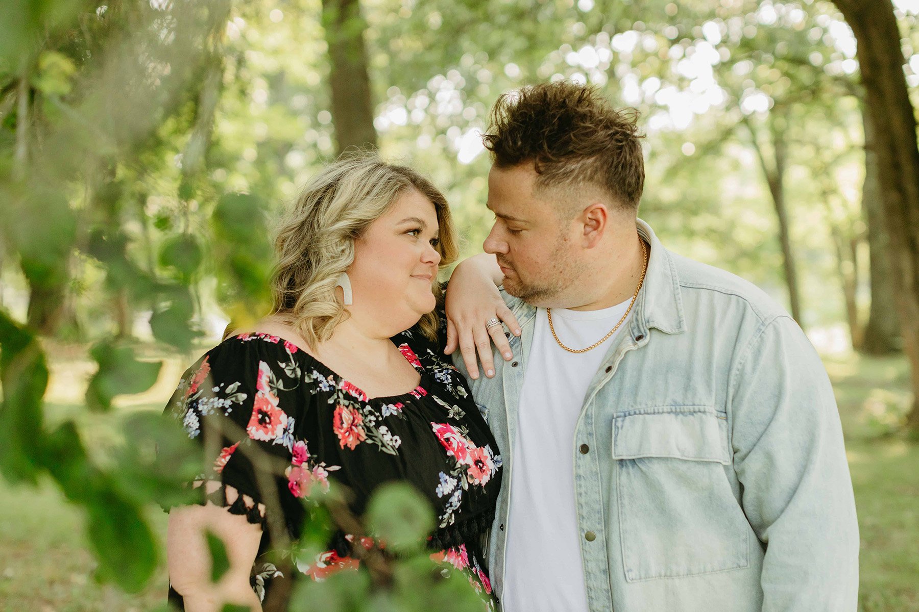 Man and woman outdoors gaze into each other's eyes lovingly.