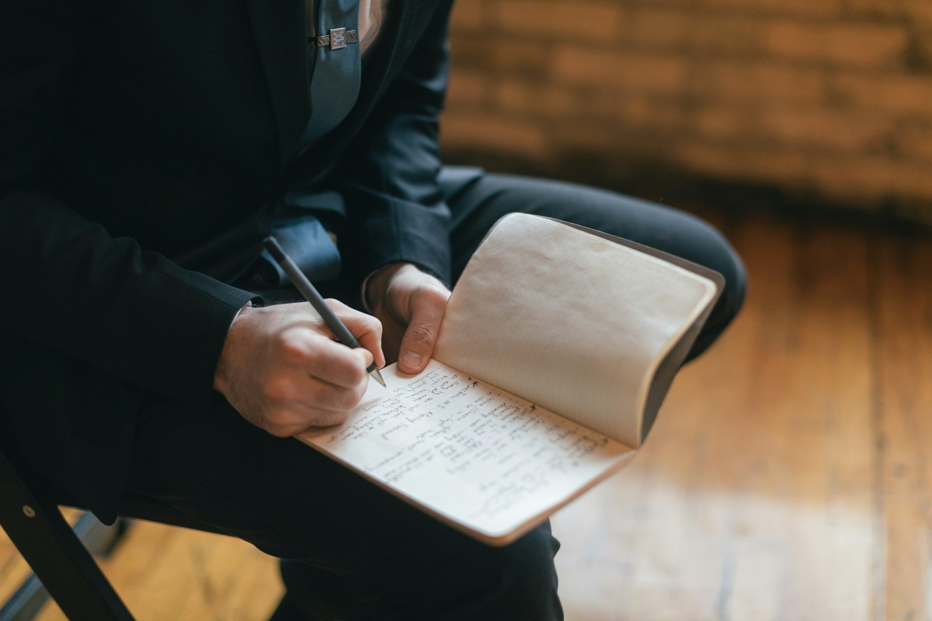 Man writes in notebook.
