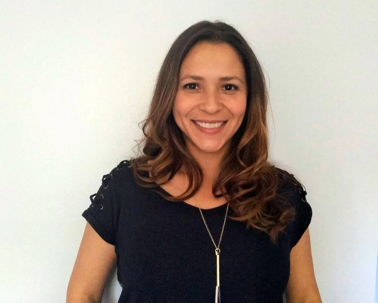 Portrait of a children's book author and artist smiling against a white background.