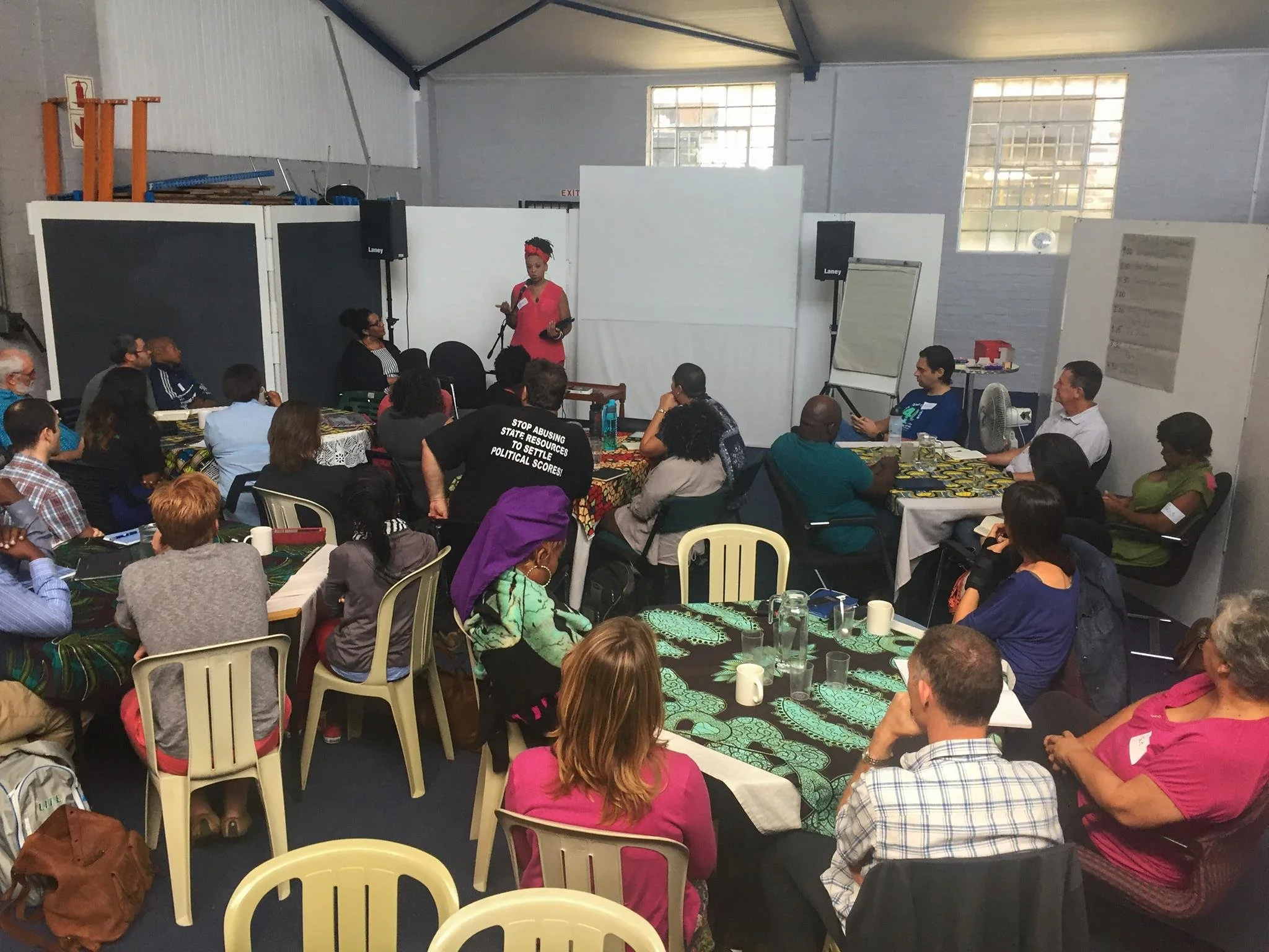 Women speaking in front of a group.