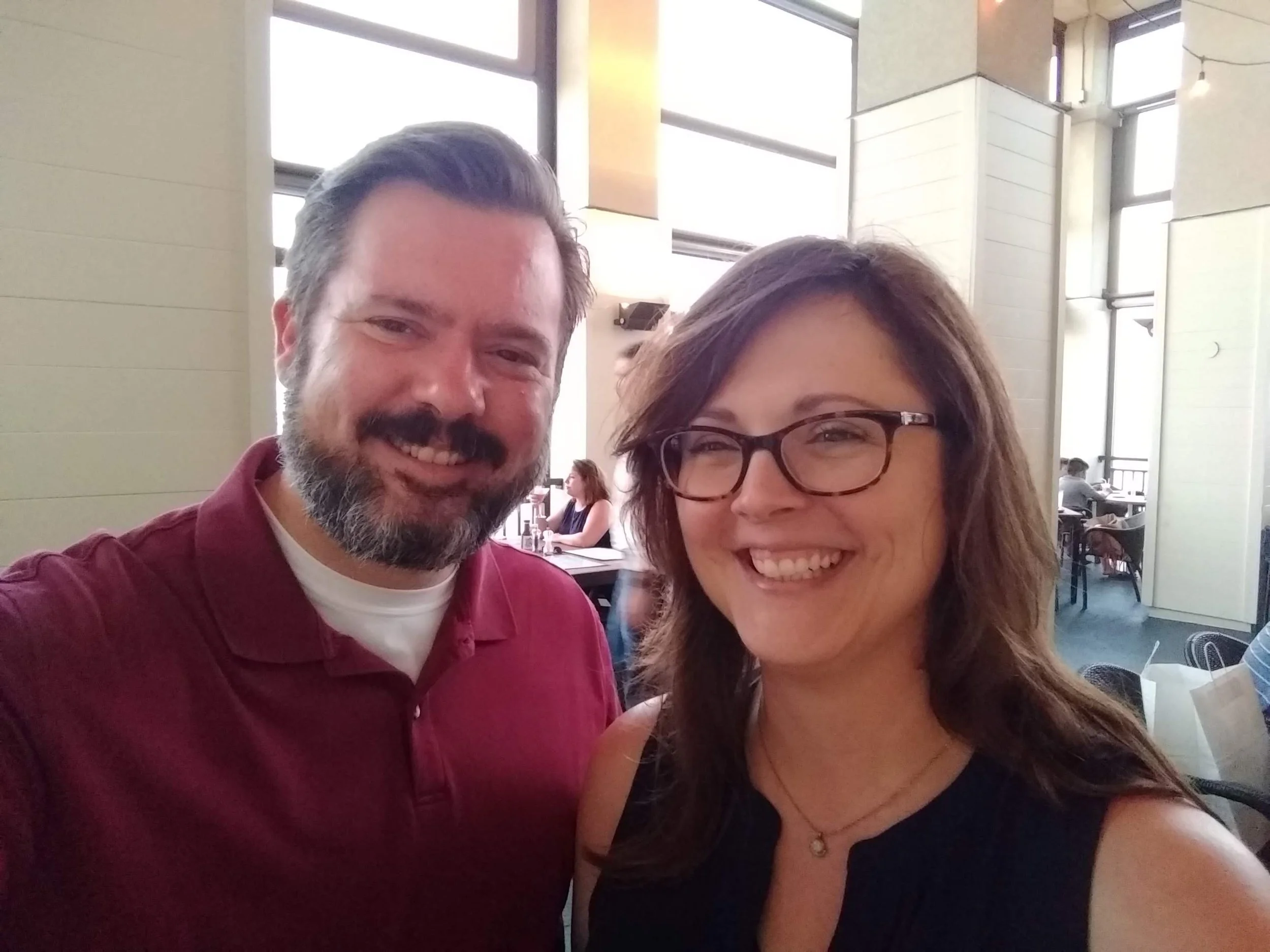 Couple smiling together during a date at a restaurant.