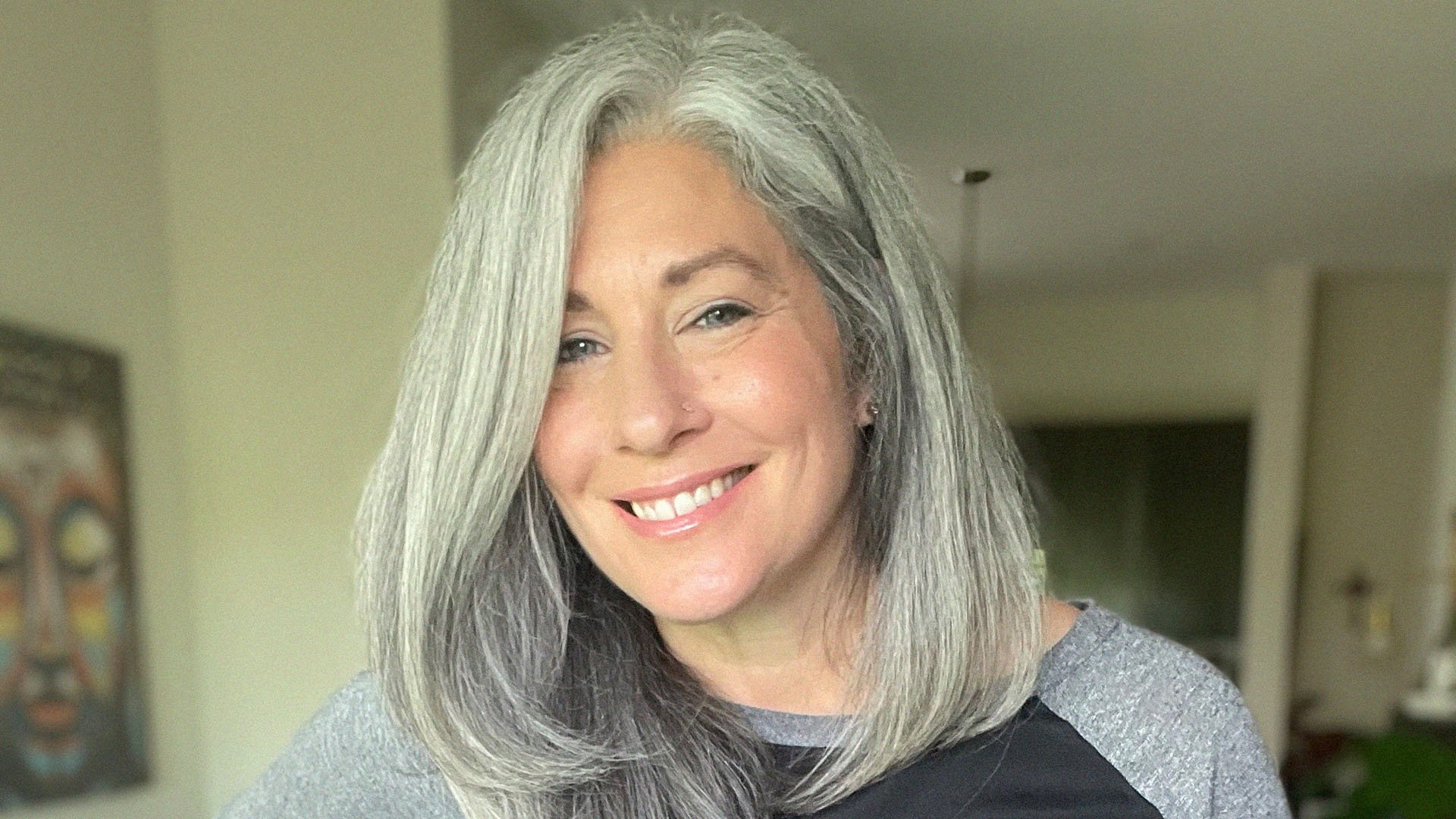 silver-haired woman looking at camera, smiling